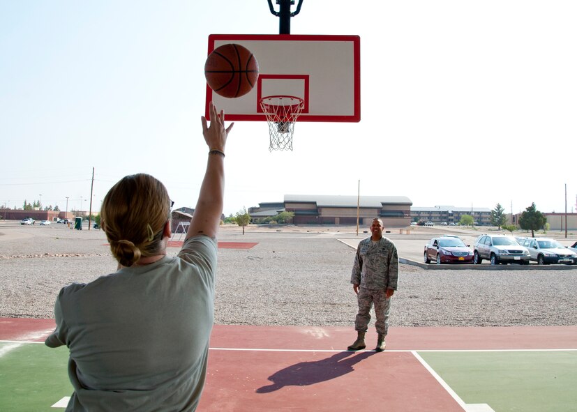 HOLLOMAN AIR FORCE BASE, N.M. – Tech. Sgt. Jean Magee, 49th Force Support Squadron, shoots a basketball during the grand opening of the outdoor covered basketball court, June 1. The outdoor covered basketball court is a new addition to the Outdoor Fitness Center, which also includes a sand volleyball court, two horseshoe pits, renovated tennis courts and two all-purpose fields.  This state-of-the-art outdoor complex is part of an ongoing quality of life initiative valued at $2.5 million. The complex aims to prove its worth by uplifting the morale and espirit de corps for Team Holloman. (U.S. Air Force photo by Airman 1st Class Colin Cates/Released) 