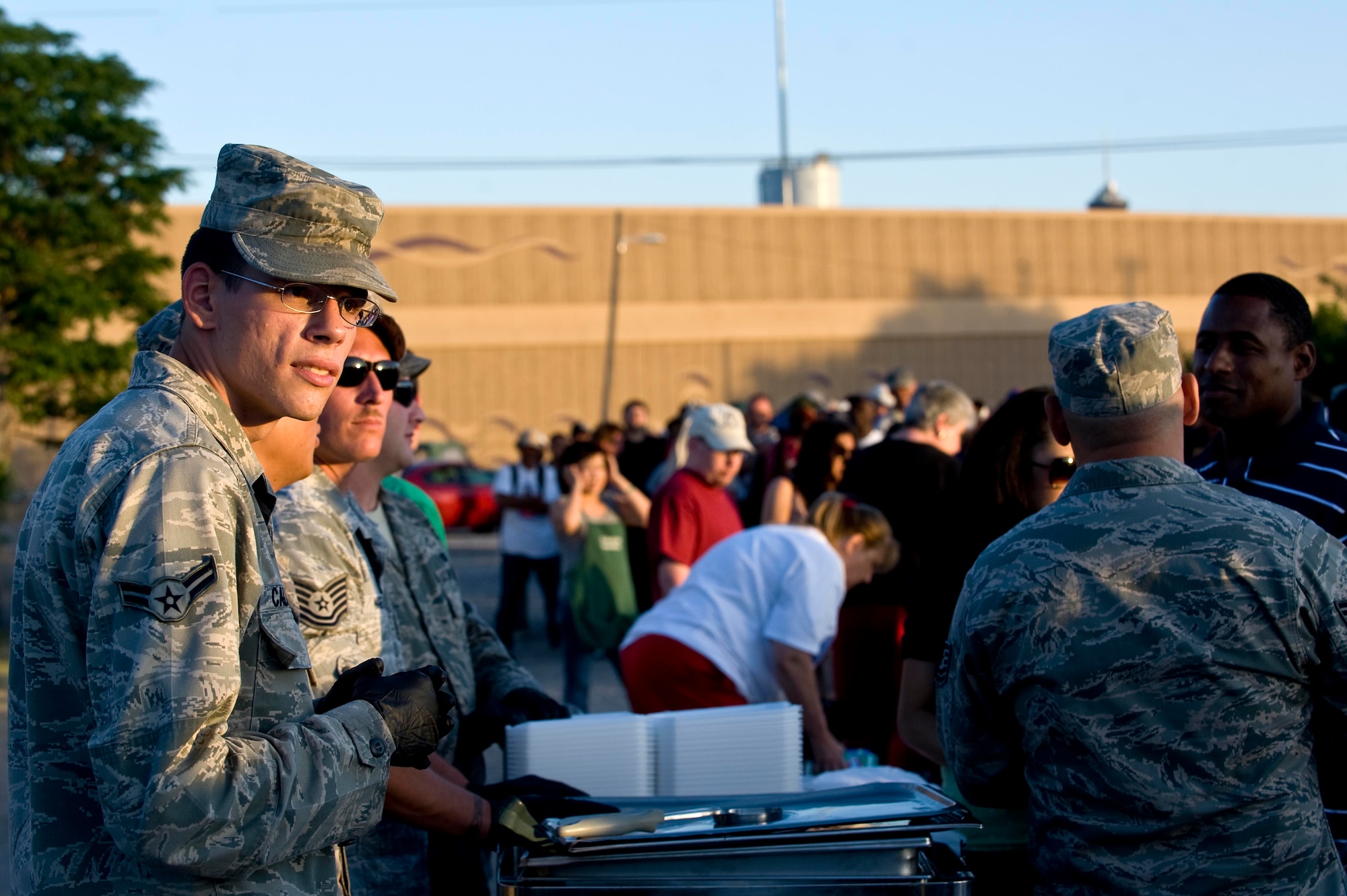 Airman 1st Class Francis Calhoun, 757th Aircraft Maintenance Squadron, waits to serve food and water to the local community during a Top-3 Food Drive for the Homeless event May 28, 2012, in Las Vegas. 57th Maintenance Group Airmen fed 250 locals during their unit's participation in Food Drive for the Homeless. (U.S. Air Force photo by Staff Sgt. Christopher Hubenthal)