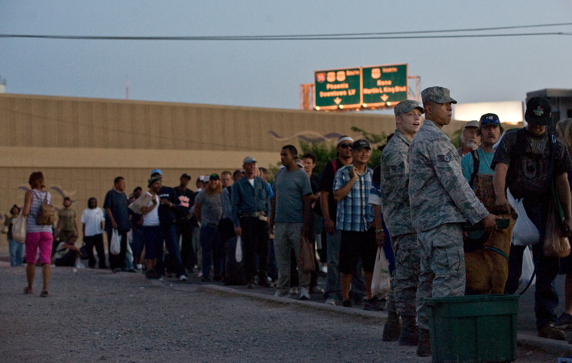 U.S. Air Force Staff Sgt. Oscar Peters and Senior Airman Eric McClendon, 57th Maintenance Group, Nellis Air Force Base, Nev., wait to hand out trays to locals during a Top-3 Food Drive for the Homeless event May 28, 2012, in Las Vegas. Every month, a different squadron or unit from Nellis volunteers time to the Top-3 Food Drive for the Homeless event. (U.S. Air Force photo by Staff Sgt. Christopher Hubenthal)