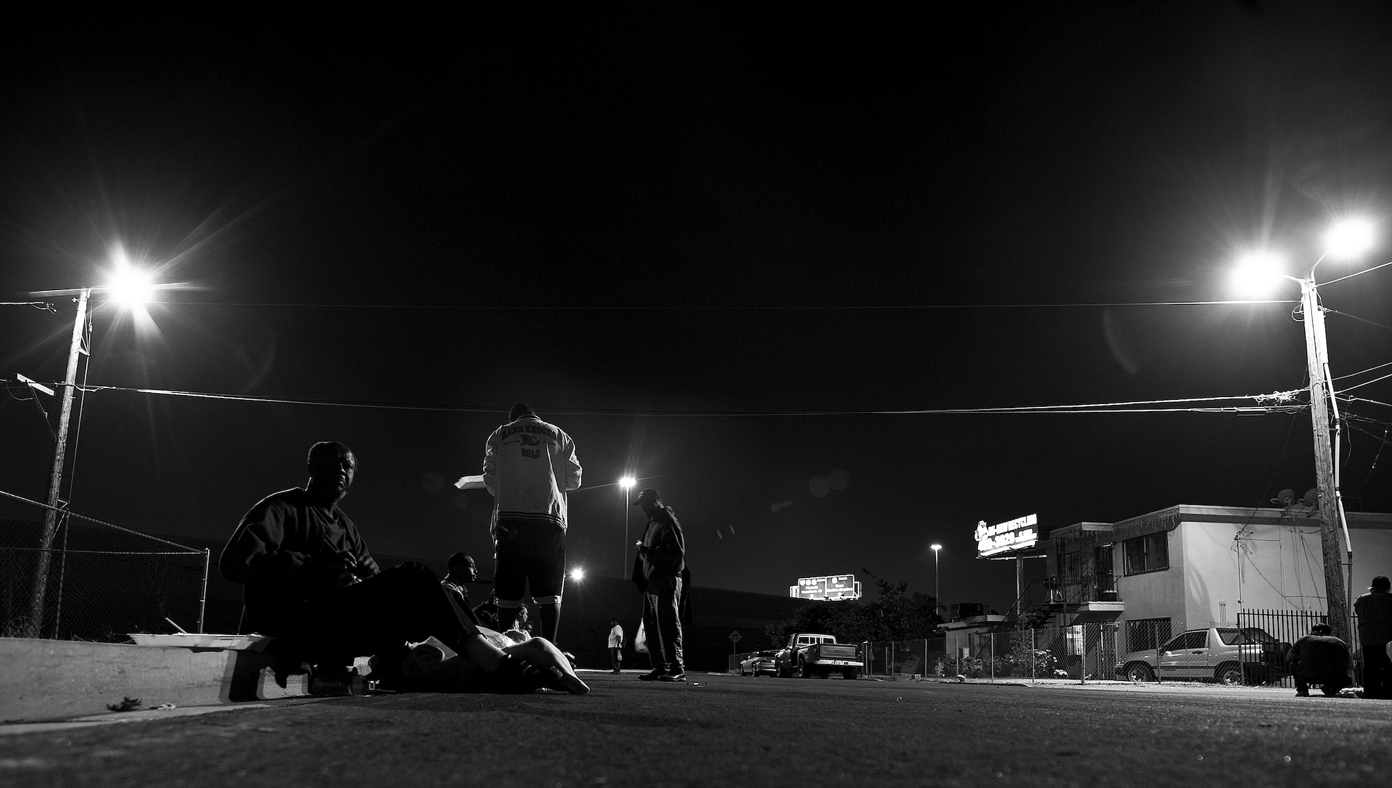 Several local men eat a provided meal during a monthly Top-3 Food Drive for the Homeless event Apr. 30, 2012, in Las Vegas. The drive reaches out to underserved neighborhoods with high homeless populations, where donated resources are often at a premium. (U.S. Air Force photo by Airman 1st Class Daniel Hughes)