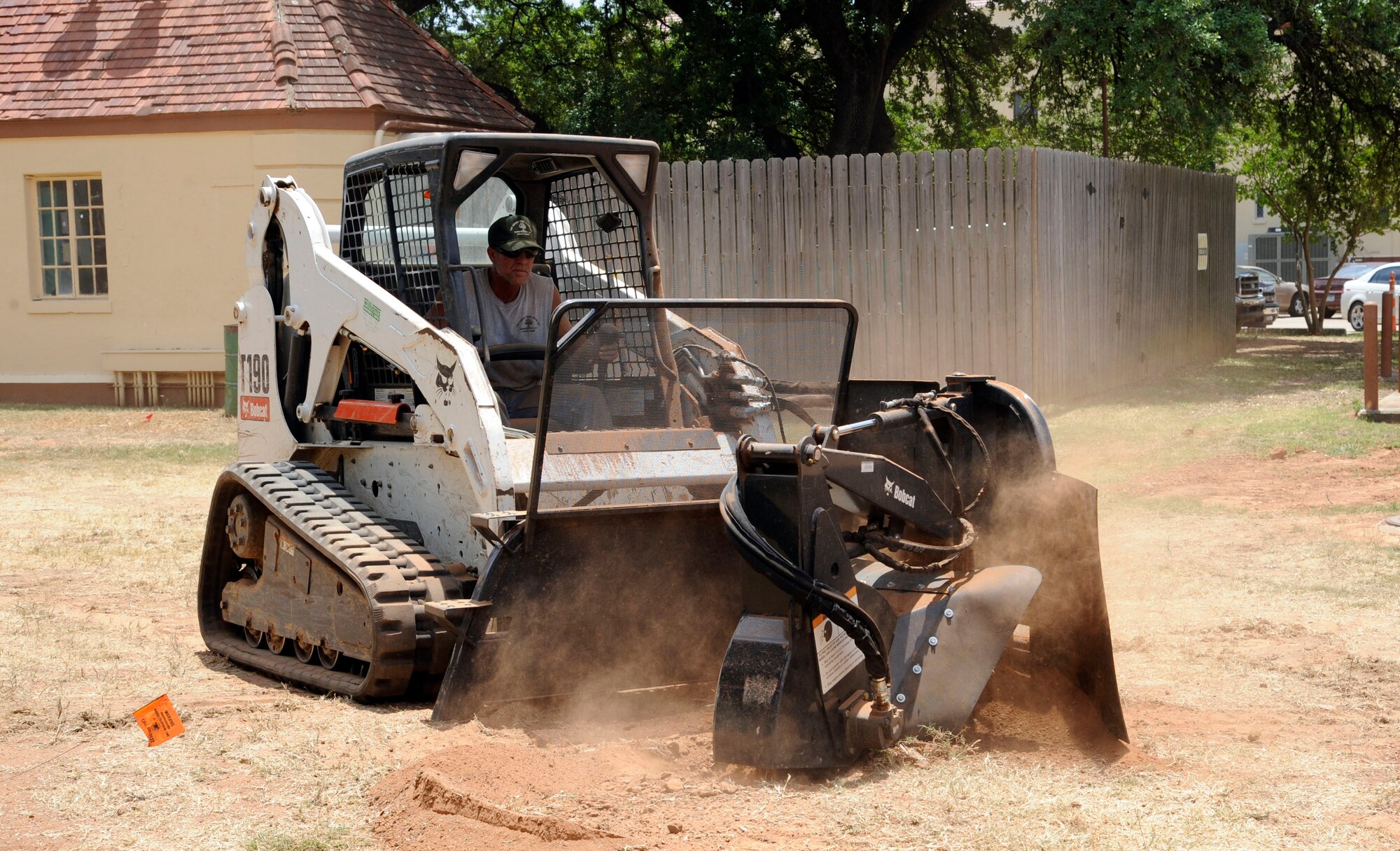 Chris Harris, a contracted worker, bores holes in the ground with a Bobcat T190 stump grinder on Barksdale Air Force Base, La., June 5. The holes will be filled with newly planted trees to replace the ones that were cut down to make room for the new parking lots on the corners of Davis Avenue and Vandenberg Street which are set to be completed by July. (U.S. Air Force photo/Airman 1st Class Andrew Moua)(RELEASED) 
