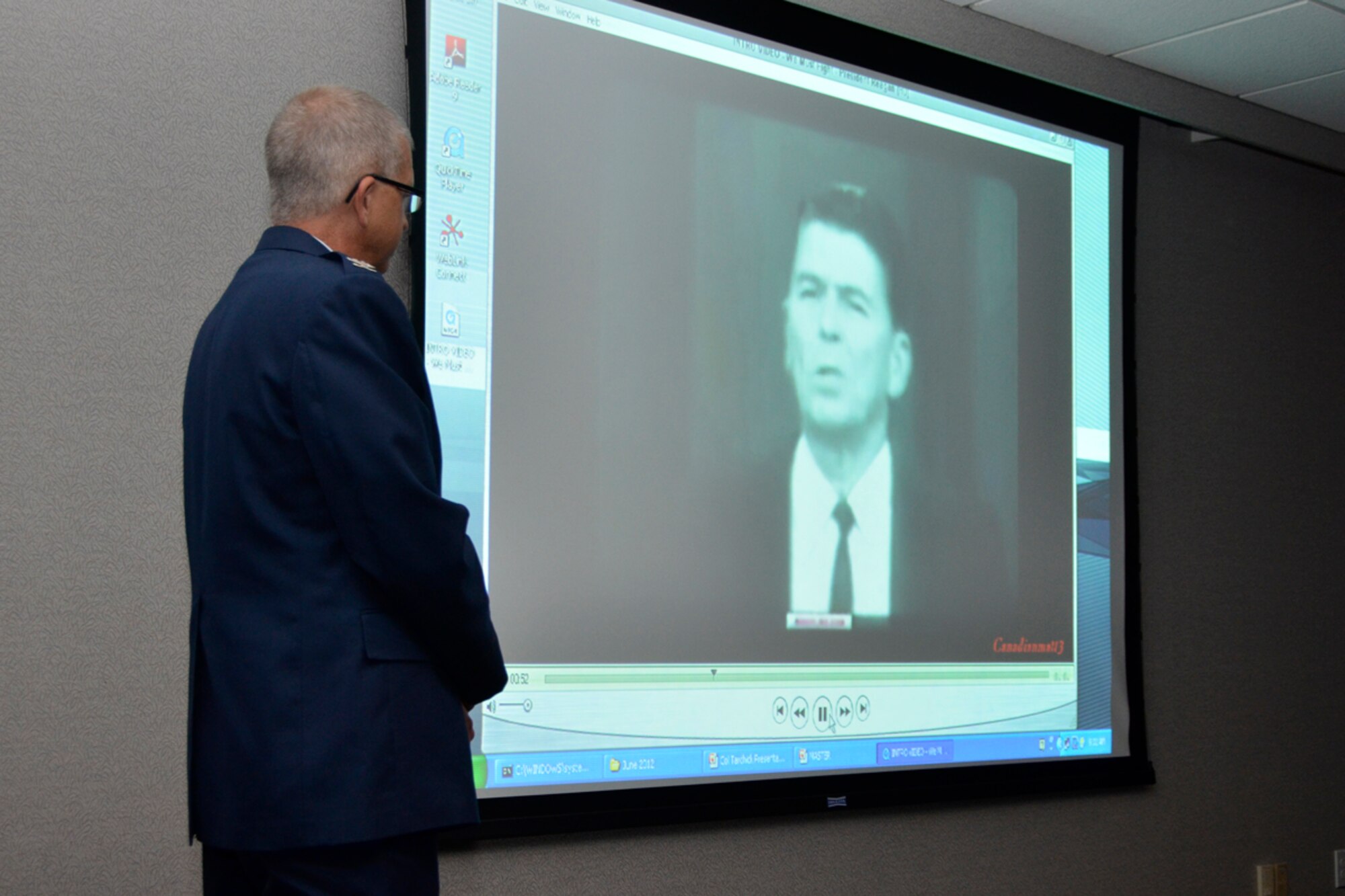 Col. Tim Tarchick, 94th Airlift Wing commander, views a video clip featuring a speech from President Ronald Reagan, “We Must Fight” prior to addressing members of the Cobb Chamber at their Board of Directors meeting in Marietta, Ga., June 4. (U.S. Air Force photo/Master Sgt. James Branch)