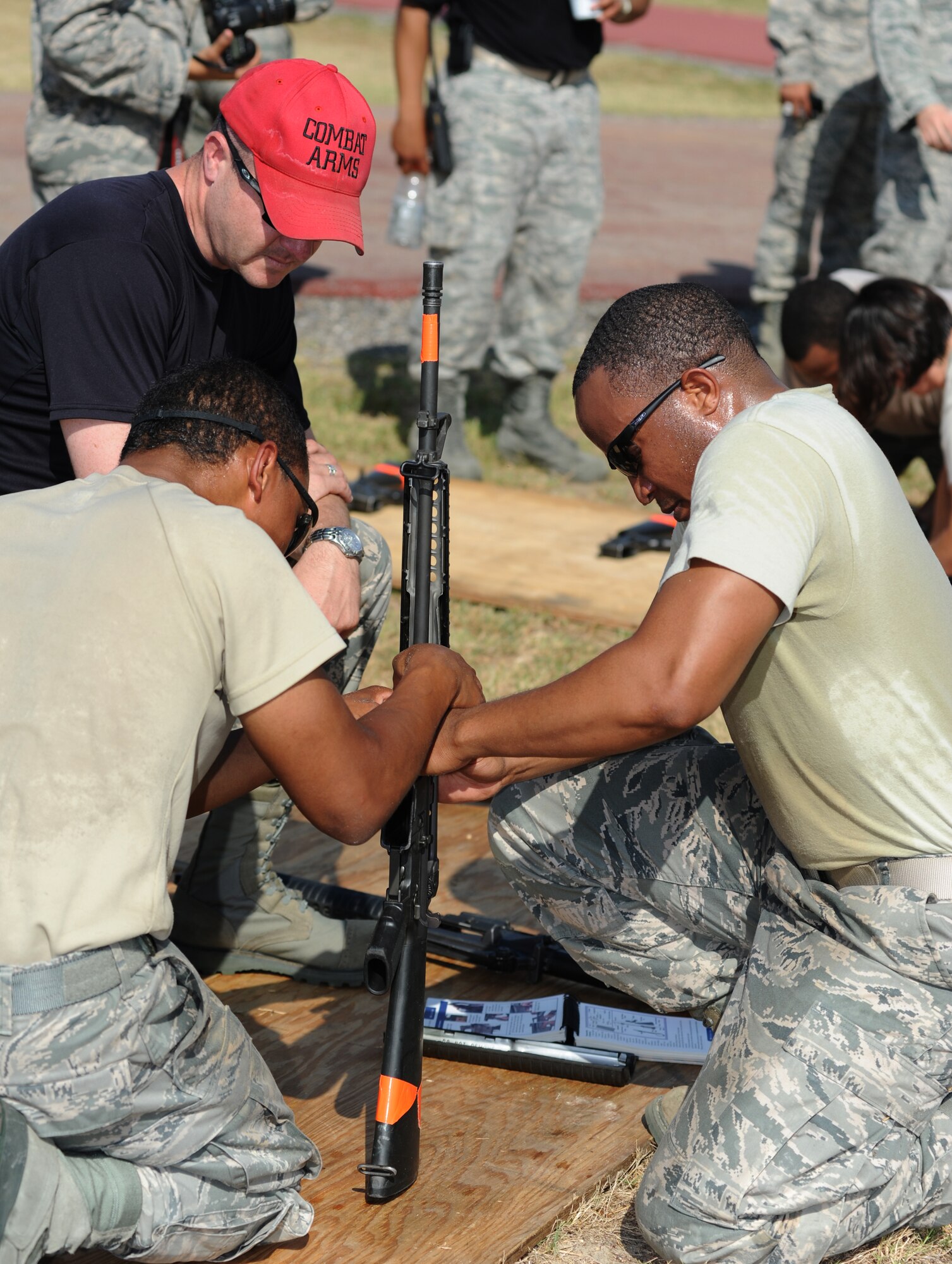 By the watchful eye of Staff Sgt. Sean Bowes, 81st Security Forces Squadron combat arms, Money Badgers team members Senior Airman T. J. Foxon and Staff Sgt. Jamal Kareem, 81st Contracting Squadron, work together to assemble a M4 weapon in the “Combat Arms Weapons” challenge during the 81st Mission Support Group Ultimate Warrior Challenge June 1, 2012, at the Triangle Track at Keesler Air Force Base, Miss. The challenge was held in honor of fellow service members who lost their lives in the fight for our nation’s freedom. It consisted of nine four-member teams racing in a competition designed to take them through various aspects of a deployment. (U.S. Air Force photo by Kemberly Groue)