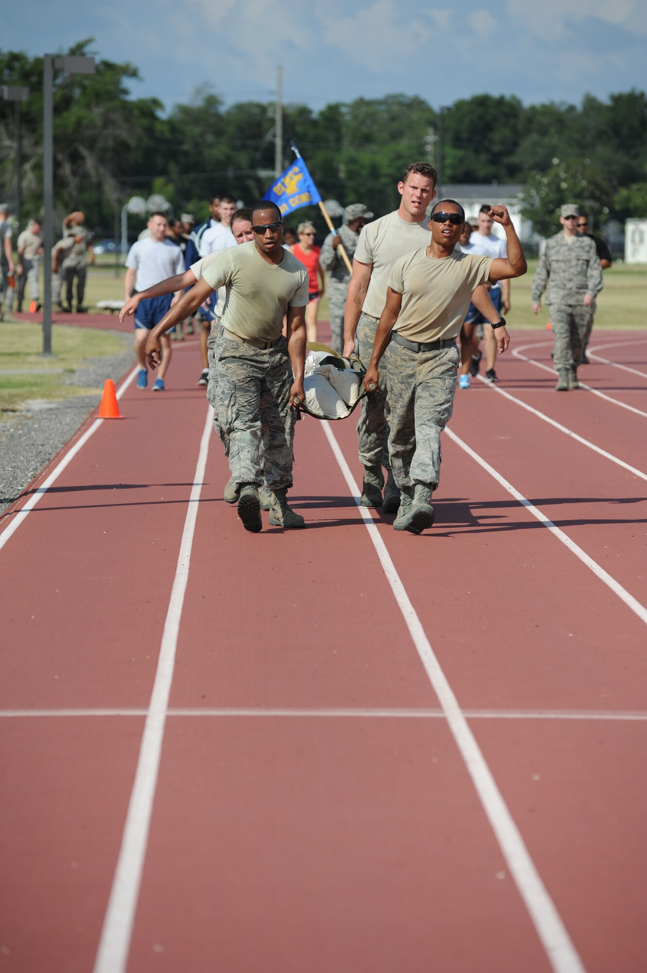 Senior Airman Amanda Nesbitt, Staff Sgt. Jamal Kareem, Second Lt. Steve Shaffer and Senior Airman T.J. Faxon, The Money Badgers from the 81st Contracting Squadron, compete in the “Litter Carry” challenge during the 81st Mission Support Group Ultimate Warrior Challenge June 1, 2012, at the Triangle Track at Keesler Air Force Base, Miss.  The challenge consisted of retrieving four sandbags, placing them securely on a litter and carry to the next challenge starting point.  The challenge was held in honor of fellow service members who lost their lives in the fight for our nation’s freedom. It consisted of nine four-member teams racing in a competition designed to take them through various aspects of a deployment. The Ram Rods were the first place winners of the Ultimate Warrior Challenge.  (U.S. Air Force photo by Kemberly Groue)