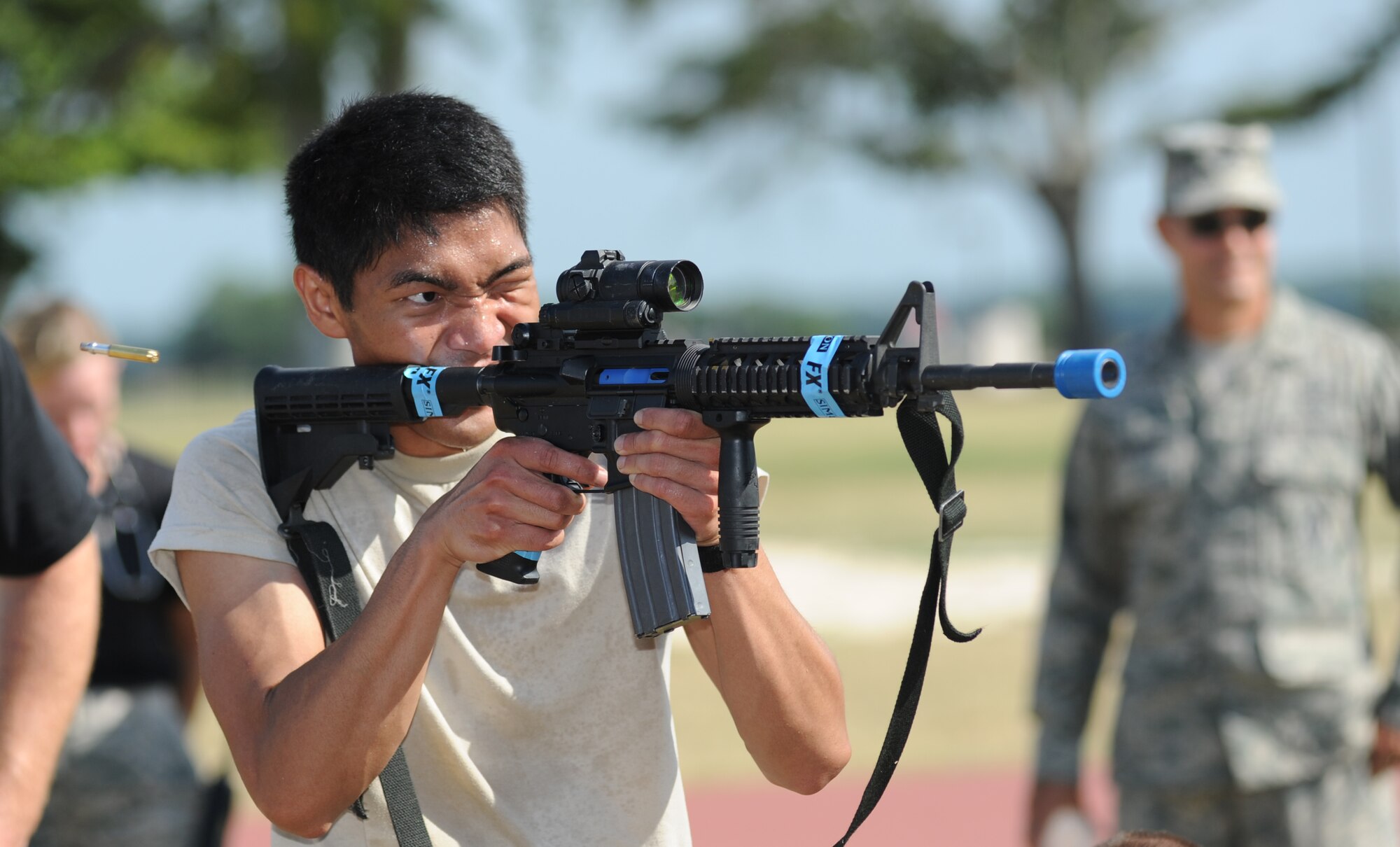 Shock and Awe team member Airman 1st Class Xeng Xiong, 81st Force Support Squadron, fires an M4 weapon at a target 10 meters away in the “Combat Arms Weapons” challenge during the 81st Mission Support Group Ultimate Warrior Challenge June 1, 2012, at the Triangle Track at Keesler Air Force Base, Miss. The challenge was held in honor of fellow service members who lost their lives in the fight for our nation’s freedom. It consisted of nine four-member teams racing in a competition designed to take them through various aspects of a deployment.  (U.S. Air Force photo by Kemberly Groue)
