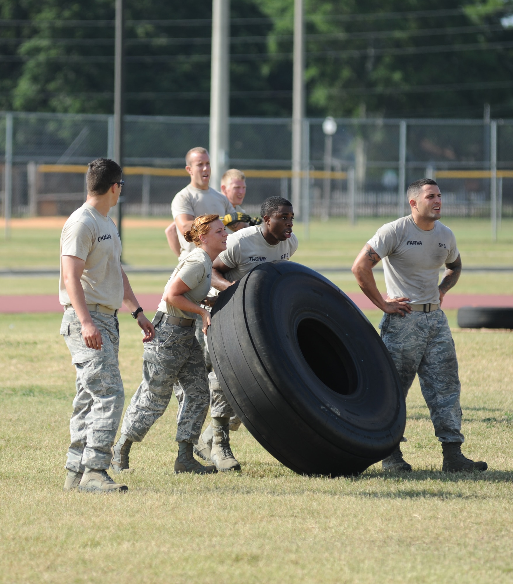 Ram Rod team members from the 81st Security Forces Squadron, Capt. Chris Porta, Staff Sgt. Audrey Spoor, Senior Airman Justin Gachett and Staff Sgt. Christopher Hernandez, compete in the “Tire Toss” challenge during the 81st Mission Support Group Ultimate Warrior Challenge June 1, 2012, at the Triangle Track at Keesler Air Force Base, Miss.  The challenge consists of two personnel flipping an aircraft tire to the designated location then the awaiting team members flipped it back to the start. The challenge was held in honor of fellow service members who lost their lives in the fight for our nation’s freedom. It consisted of nine four-member teams racing in a competition designed to take them through various aspects of a deployment. The Ram Rods were the first place winners of the Ultimate Warrior Challenge.  (U.S. Air Force photo by Kemberly Groue)