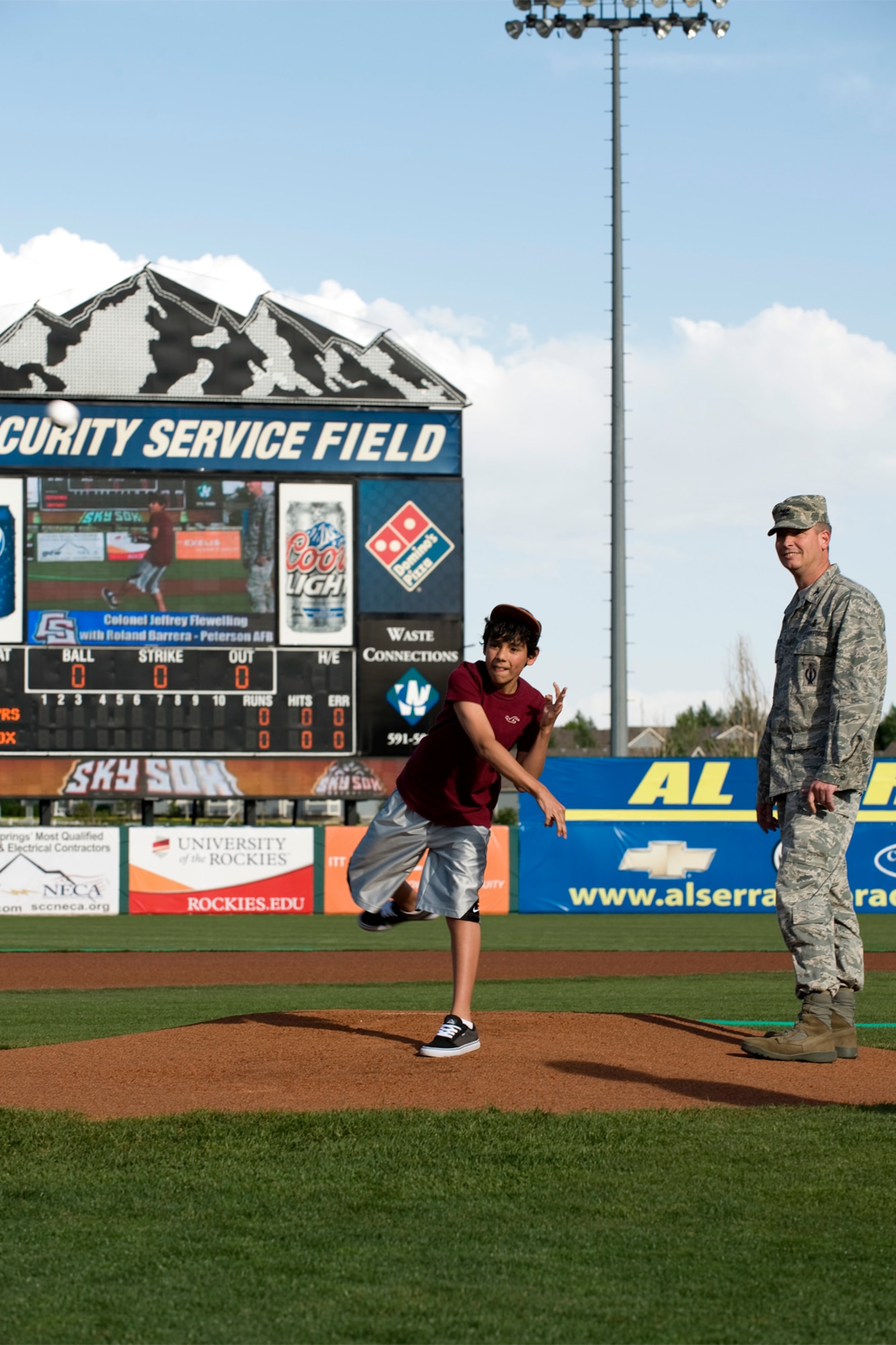COLORADO SPRINGS, Colo. – Rolando Barrera Jr., a deployed service member’s son, throws the opening pitch with Col. Jeffrey Flewelling, 21st Space Wing vice commander, for a Colorado Springs Sky Sox game May 18, 2012, at Security Service Field. The Sky Sox went on to win the game against the New Orleans Zephyrs, 4-2.  (U.S. Air Force photo/Craig Denton)