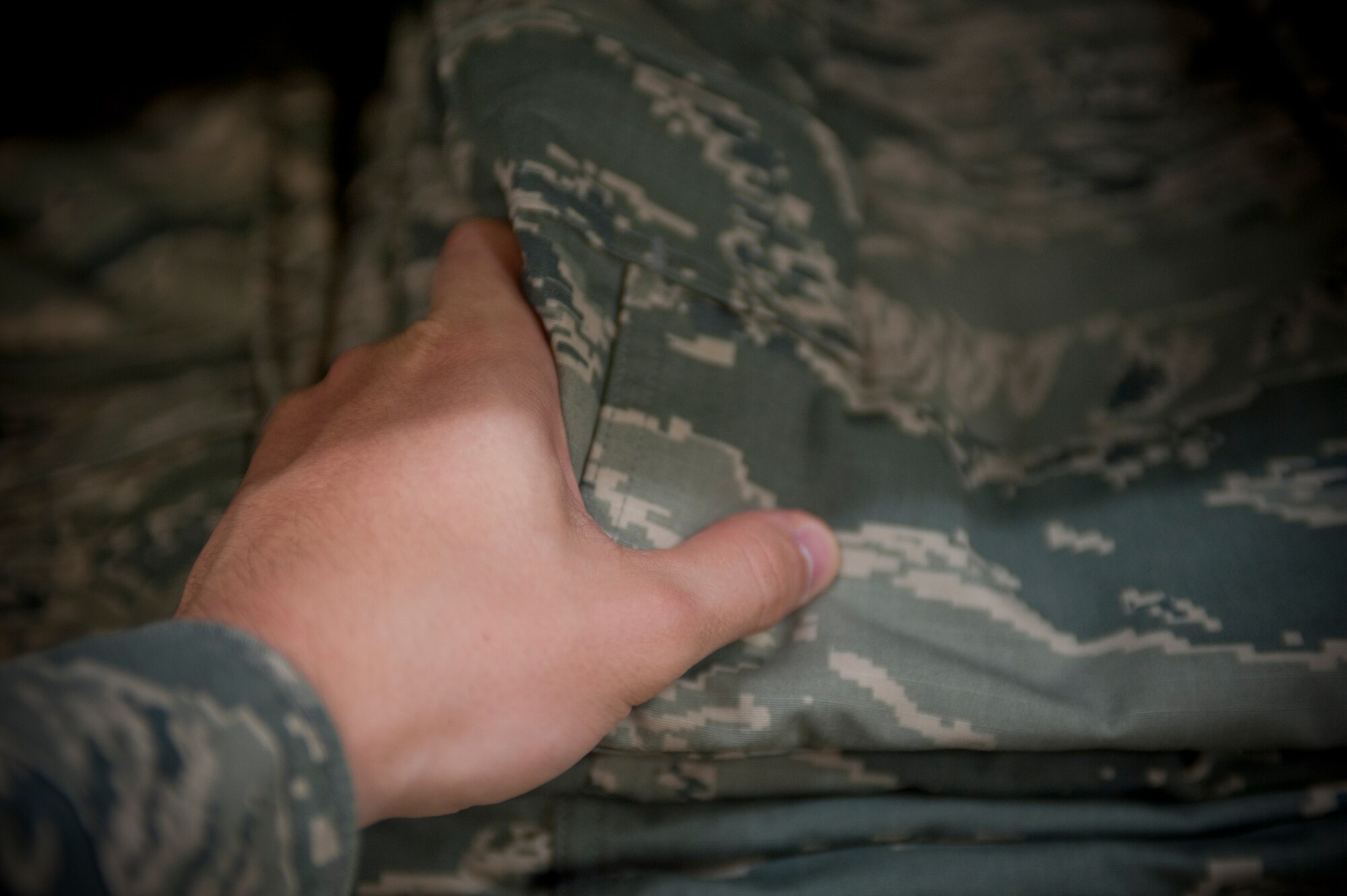 An Airman grabs a new set of Rip-stop Airman Battle Uniform trousers at Moody Air Force Base, Ga., June 6, 2012. The new uniform is now available to Airmen at 16 U.S. bases, including Moody, and through Army and Air Force Exchange Service online. For more information, call Military Clothing Sales at 229-257-4814. (U.S. Air Force photo by Airman 1st Class Douglas Ellis/Released)
