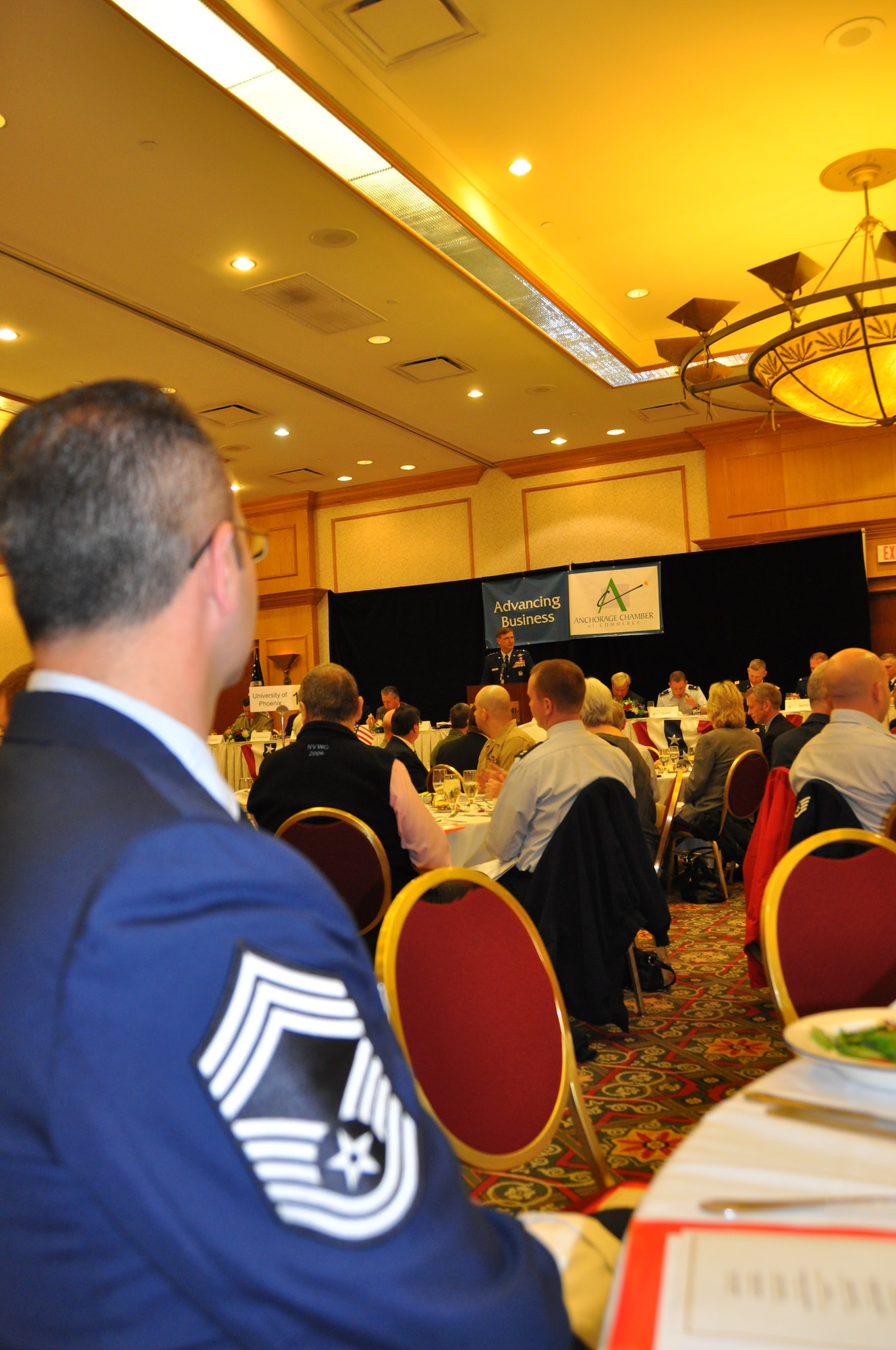 Chief Master Sgt. Tim Zellar, 477th Fighter Group chief enlisted manager, listens to Lt. Gen. Hoog commander of Alaskan Command, speak during the Anchorage Chamber of Commerce Military Appreciation lunch June 4. The lunch, held at the Anchorage Marriott Downtown Hotel, kicked off the Chamber of Commerce’s19th Annual Military Appreciation week that will conclude with a Military Appreciation Picnic June 8.  (U.S. Air Force Photo/Capt. Ashley Conner) 