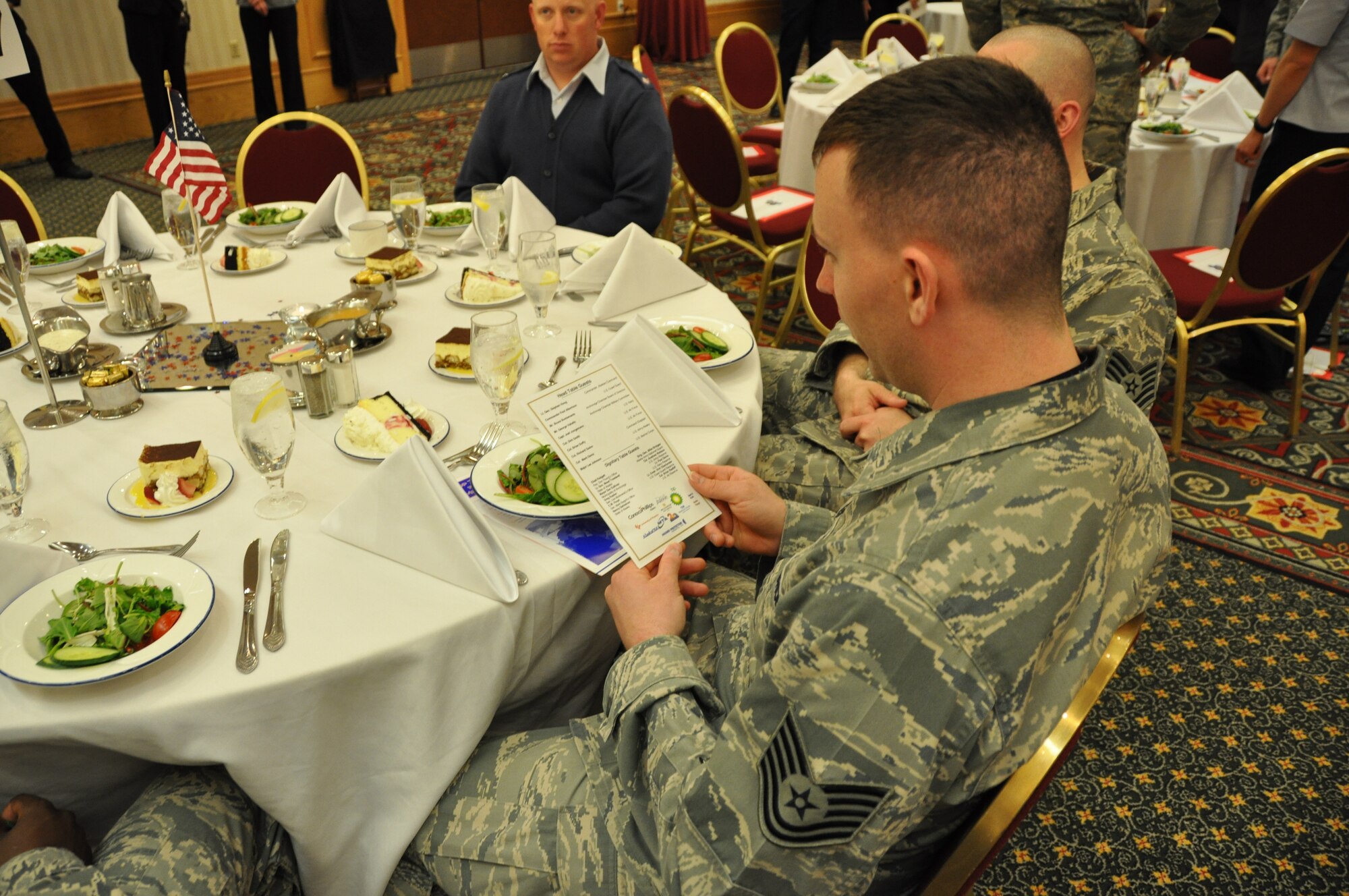 Tech. Sgt. Kevin Norris, 477th Force Support Squadron, reviews the agenda for the Anchorage Chamber of Commerce Military Appreciation lunch June 4. Lt. Gen. Stephen Hoog, commander of Alaskan Command, was this year’s keynote speaker at the lunch held at the Anchorage Marriott Downtown Hotel. This event was the first of many during the Chamber of Commerce’s19th Annual Military Appreciation week that will conclude with a Military Appreciation Picnic June 8.  (U.S. Air Force Photo/Capt. Ashley Conner) 