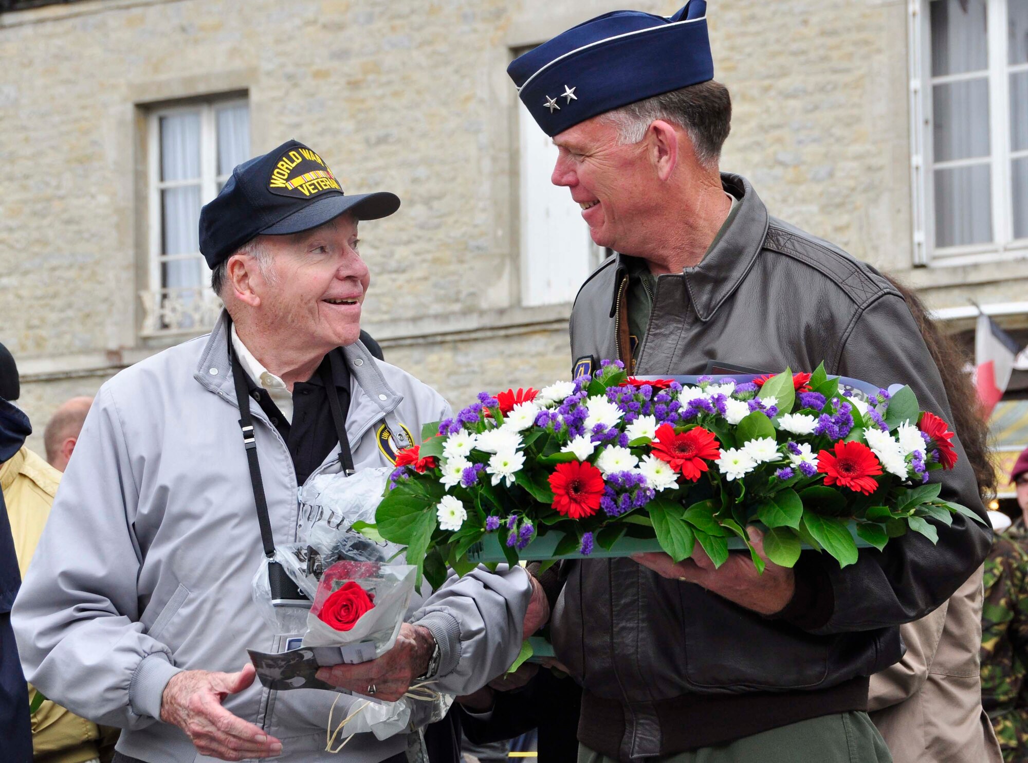 Air Force Reserve Maj. Gen. Wallace “Wade” Farris, Jr., chats with Jerome Welna, an American World War II Navy veteran June 5, 2012, before presenting a ceremonial wreath in Saint Mere Eglise, France. The wreath was laid to honor both American and Allied forces that were killed during the Normandy D-Day invasion of June 6, 1944. Earlier, service members from several nations, including the U.S., marched through the streets of this Normandy village leading up to an official ceremony commemorating the invasion’s 68th Anniversary. Leadership from the Army and U.S. Air Force, German military and local French elected officials joined with the veterans to lay ceremonial wreaths at the foot of an invasion memorial in the village. Saint Mere Eglise lays claim to fame of being one of the first villages in the Normandy region to be liberated by Allied forces in the early morning hours of June 6, 1944. Farris commands the AF Reserve’s 22nd Air Force and is based at Dobbins Air Reserve Base, Ga. Welna served aboard the U.S.S. Barton, a destroyer that supported the Normandy invasion. (U.S. Air Force photo/Staff Sgt. Stephen J. Collier)
