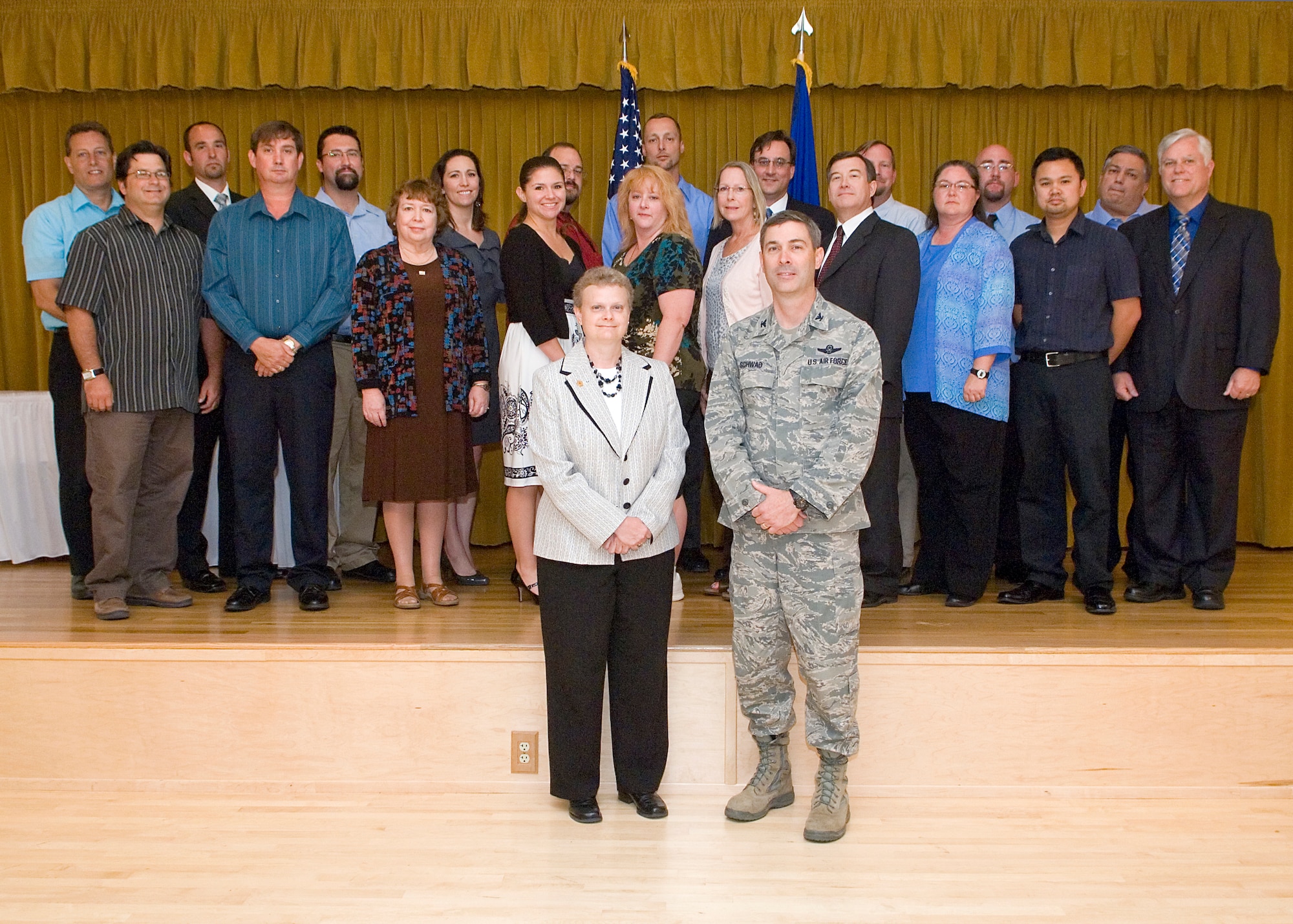 Col. Gregory Schwab, 95th Air Base Wing commander, poses with Denise Humphrey, Deputy Director, Center for Development of Security Excellence Directorate at Defense Security Service, in front of security professionals who were certified through the DSS's Security Professional Education Development program.  May 31, Team Edwards members and government civilians from the region received Department of Defense certificates for passing DOD certification tests.  (U.S. Air Force photo by Edward Cannon)