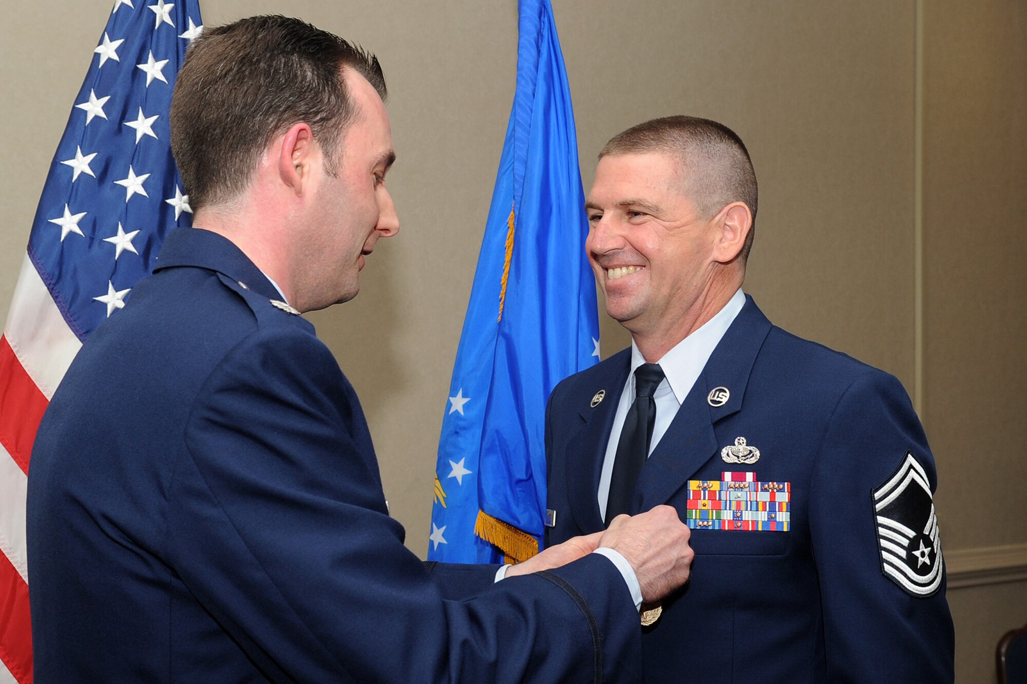 U.S. Air Force Lt. Col. Shawn Campbell pins the Meritorious Service Medal on Senior Master Sgt. Sean Applegate, Air Combat Command food service superintendent, during his promotion ceremony to chief master sergeant at Langley Air Force Base, Va., May 31, 2012. Chief master sergeants, the highest enlisted rank, with the exception of the Chief Master Sergeant of the Air Force, serve as key leaders at all levels of the Air Force. (U.S. Air Force photo by Airman 1st Class Racheal Watson/Released)