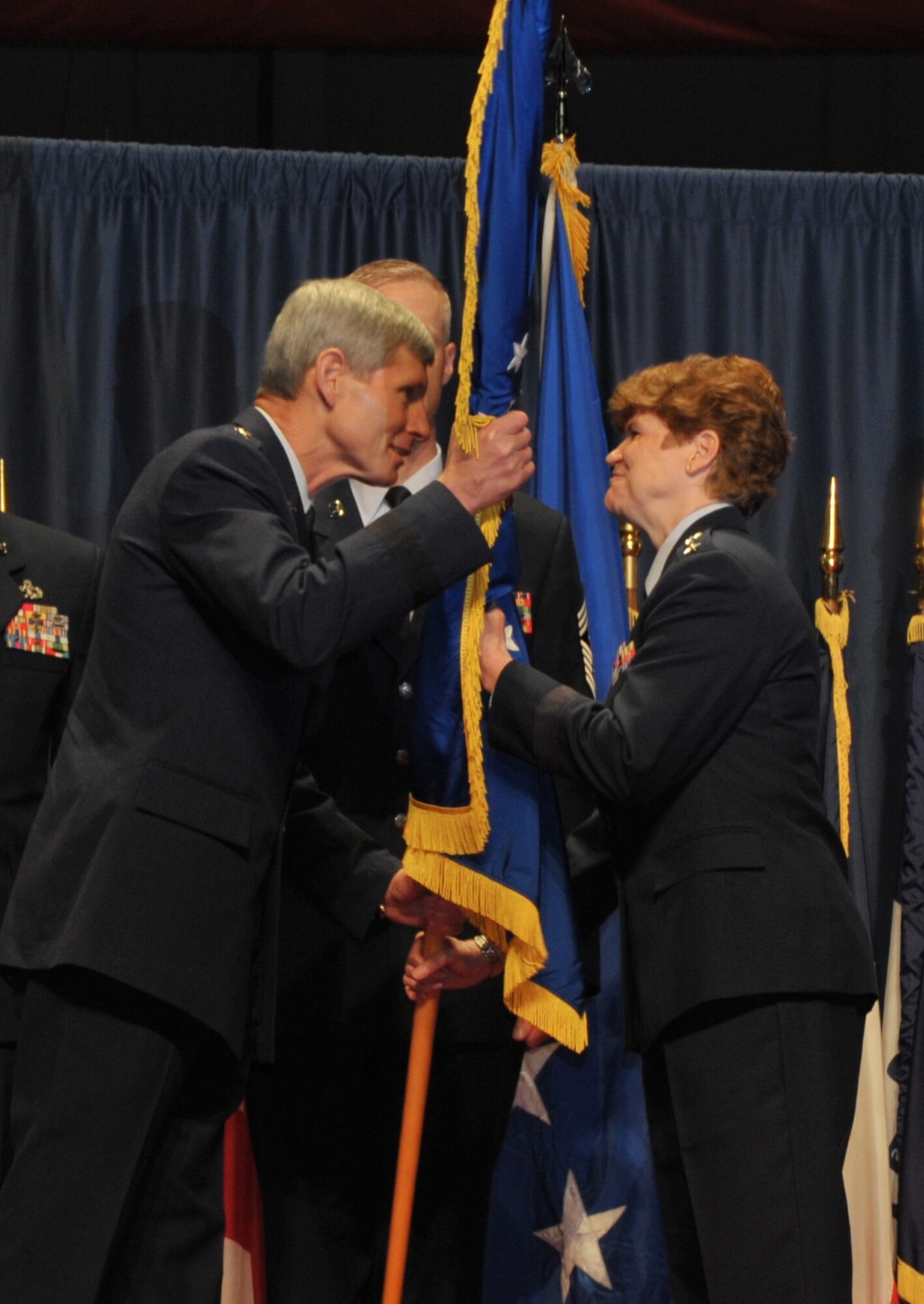 In the time-honored military tradition signifying assumption of command, Air Force Chief of Staff Gen. Norton Schwartz passes the Air Force Materiel Command guidon, or unit flag, to Gen. Janet Wolfenbarger. Wolfenbarger assumed command of AFMC June 5, 2012, in a ceremony at the National Museum of the U.S. Air Force. (U.S. Air Force photo/Michelle Gigante)