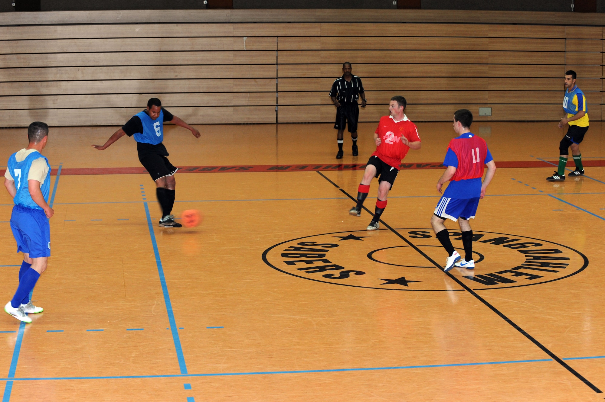 SPANGDAHLEM AIR BASE, Germany – Robert Ivey, 52nd Civil Engineer Squadron, kicks a soccer ball during game one of an intramural double-elimination soccer tournament at the Skelton Memorial Fitness Center gym here June 4. The 52nd Force Support Squadron team beat the 52nd CES team 4 - 2 in the opening game of the tournament. The eight teams with the best records during the season compete in this tournament, and the first and second place teams will be presented with trophies after the final game. (U.S. Air Force photo by Senior Airman Christopher Toon/Released)