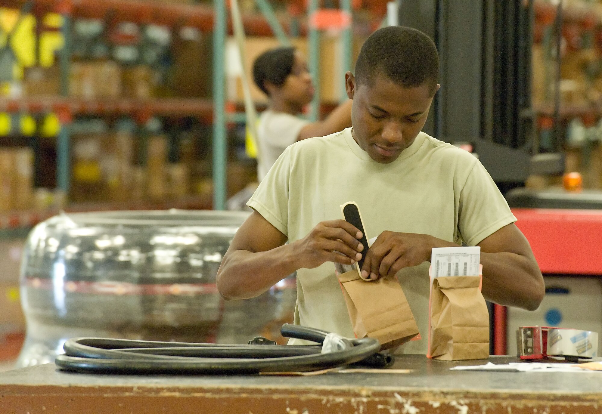 Airman 1st Class Jeffson Dorvil, storage and issue apprentice with the 436th Logistics Readiness Squadron, staples inventory bags May 30, 2012, at Dover Air Force Base, Del. The 436th LRS Aircraft Parts Store inventories 32,000 aircraft parts valued at more than $9 million in support of 31 assigned aircraft. (U.S. Air Force photo by Roland Balik)