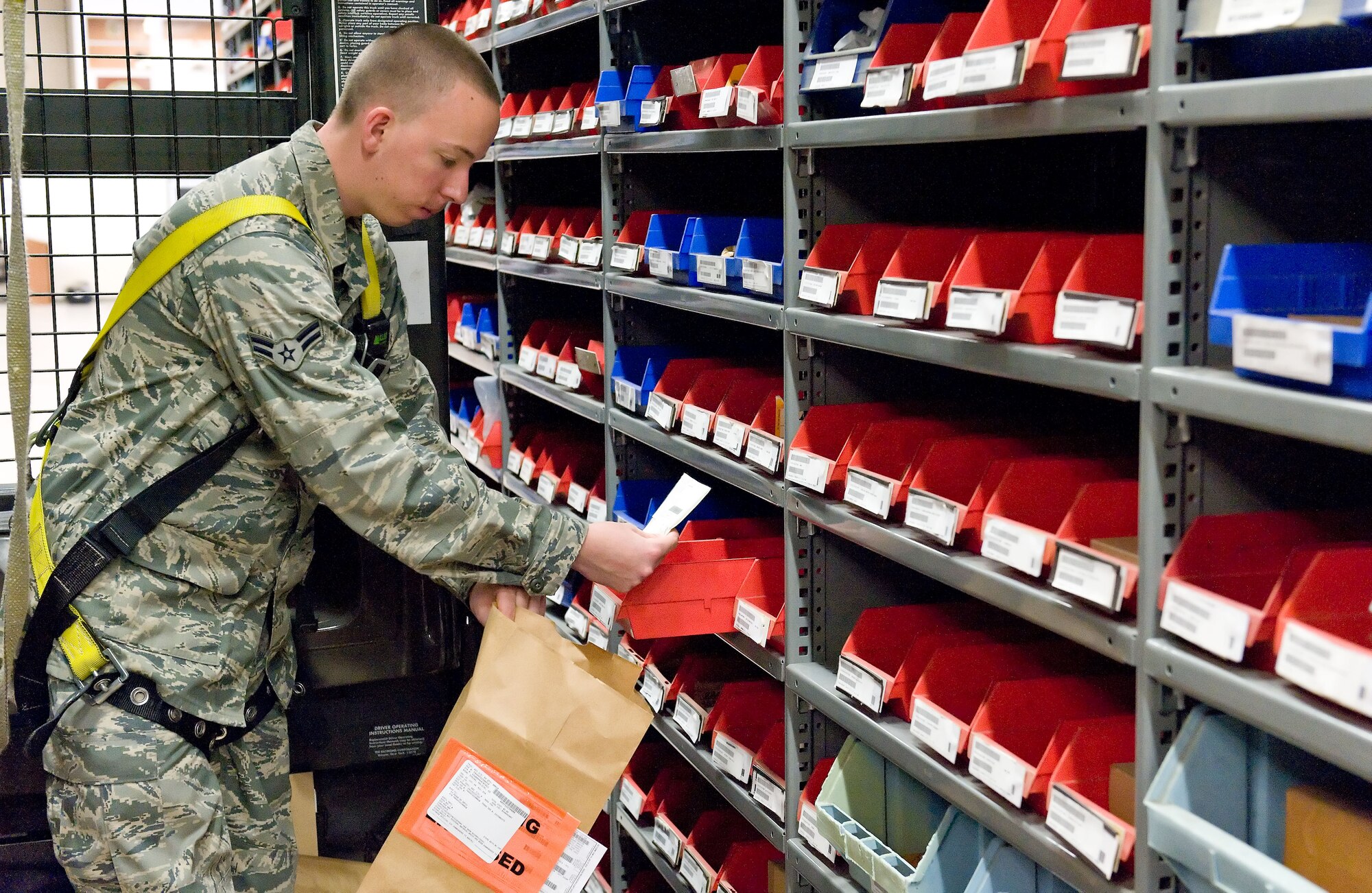 Airman 1st Class Tai Cartwright, storage and issue apprentice with the 436th Logistics Readiness Squadron, pulls inventory from the shelves of the 436th LRS Aircraft Parts Store May 30, 2012, at Dover Air Force Base, Del. The 436th LRS Aircraft Parts Store inventories 32,000 aircraft parts valued at more than $9 million in support of 31 assigned aircraft. (U.S. Air Force photo by Roland Balik)