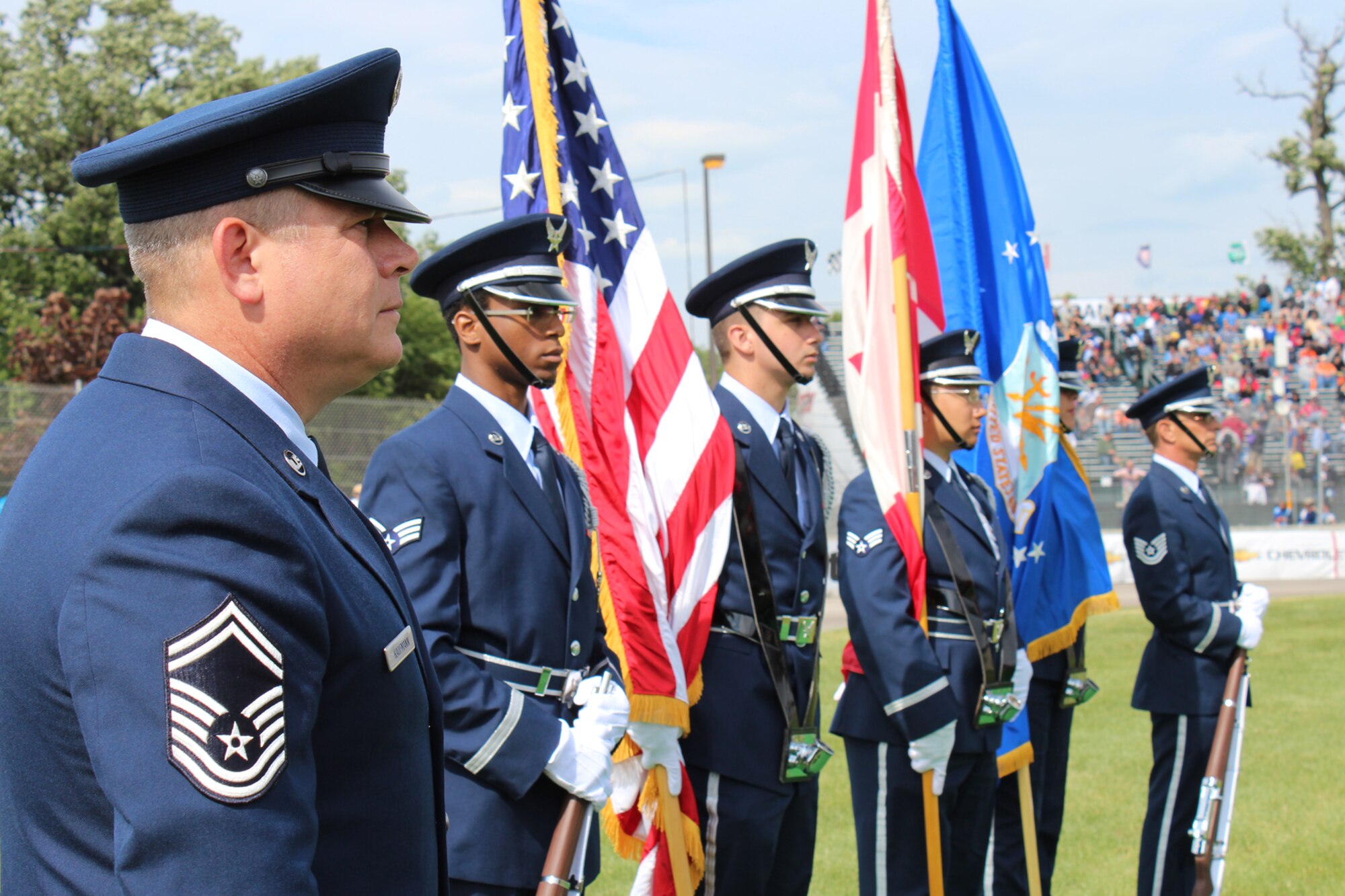 Senior Master Sgt. Mark Kaufmann (left), 127th Civil Engineer Squadron, and members of the 127th Wing Honor Guard wait for pre-race festivities to kick off before the Chevrolet GRAND-AM 200 race at the Belle Isle Grand Prix in Detroit June 2. Grand Prix officials invited 30 military members from Team Selfridge to participate in pre-race activities throughout the race weekend as a way to show their military appreciation. (U.S. Air Force photo by Angela Pope) 