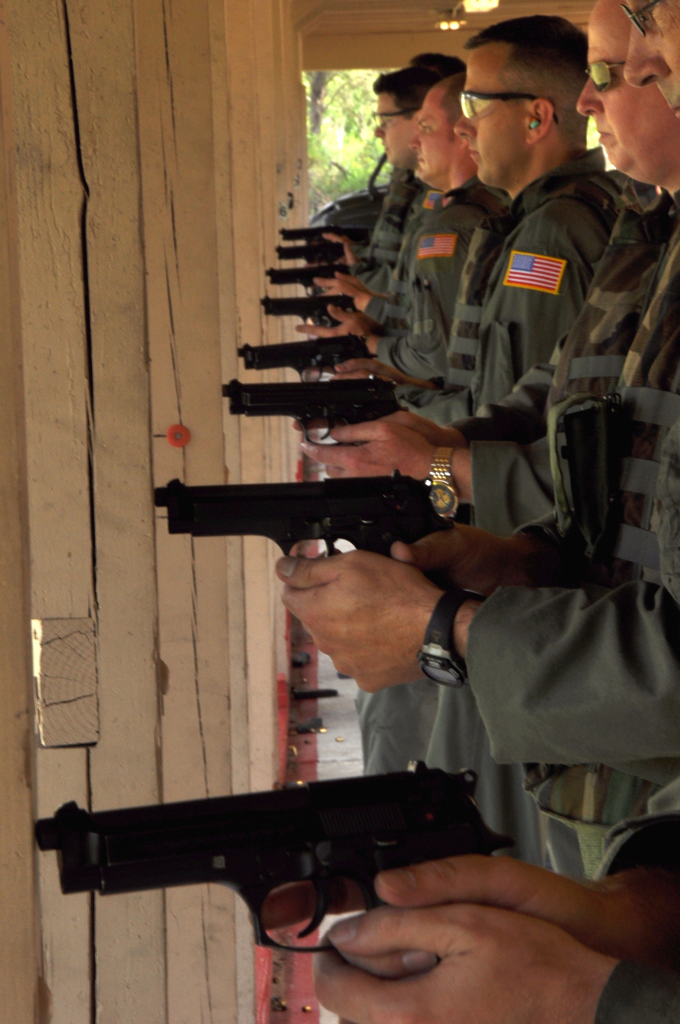 MACDILL AIR FORCE BASE, Fla. – Members of the 927th Air refueling Wing line up at the firing range as part of a new course of fire.  The unit was the first in the entire Air Force Reserve Command to institute the new firing course, which teaches firing while moving, target recognition, and effective use of cover. (Official U.S. Air Force photo/Staff Sgt. Shawn Rhodes)