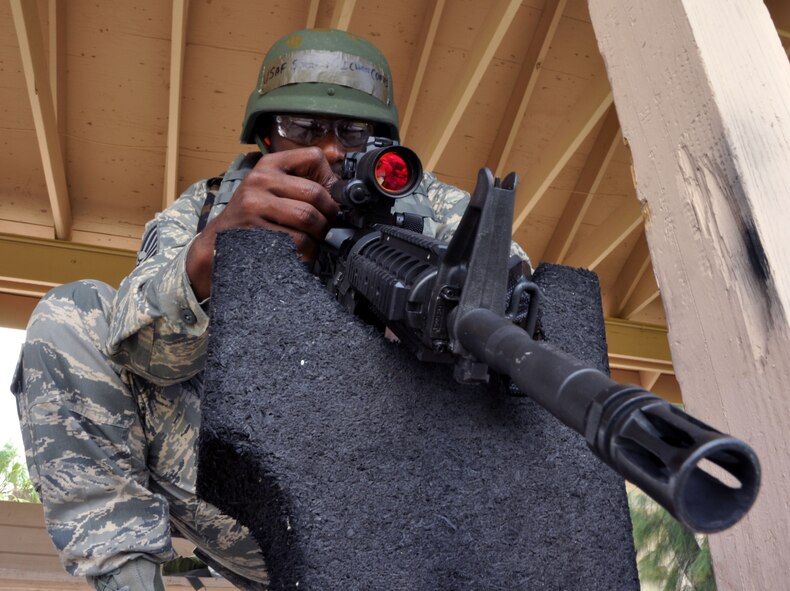 MACDILL AIR FORCE BASE, Fla. -- Technical Sgt. Michael Coates, an aircraft engine mechanic with the 927th Aircraft Maintenance Squadron, takes a break during his course of fire to adjust the sights on his M-4 Carbine.  The new Air Force Rifle/Carbine Qualification Course gives all airmen - even reservists – the opportunity to learn how to survive urban combat situations. (Official U.S. Air Force photo/Staff Sgt. Shawn Rhodes)