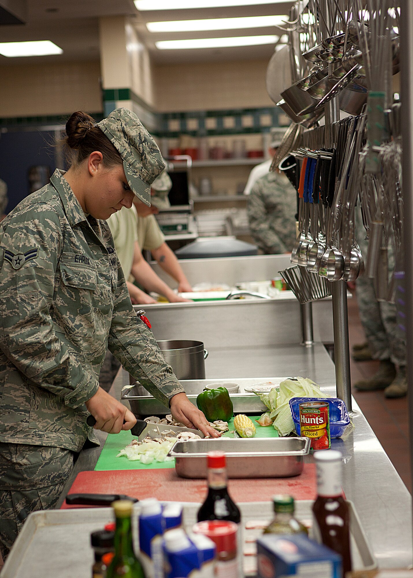 Airman 1st Class Elizabeth Ehrlick, 90th Force Support Squadron, prepares a dish during the 2nd Quarter Chefs Competition May 17 in the Chadwell Dining Facility. (U.S. Air Force photo by Matt Bilden)