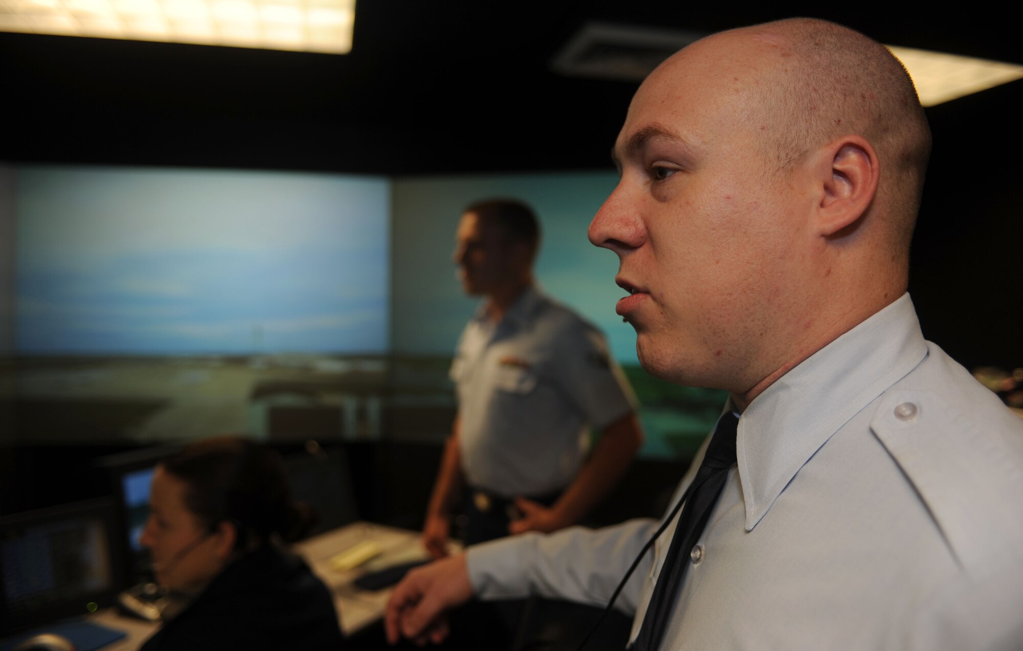 Airman 1st Class Sean Harrell, 1st Operations Support Squadron air traffic control apprentice, relays information to incoming aircraft during a training exercise at Langley Air Force Base, Va., June 4. To expedite the process of information relay, air traffic controllers learn new, specific terms for any situation. (U.S. Air Force photo by Airman 1st Class Austin C. Harvill) 