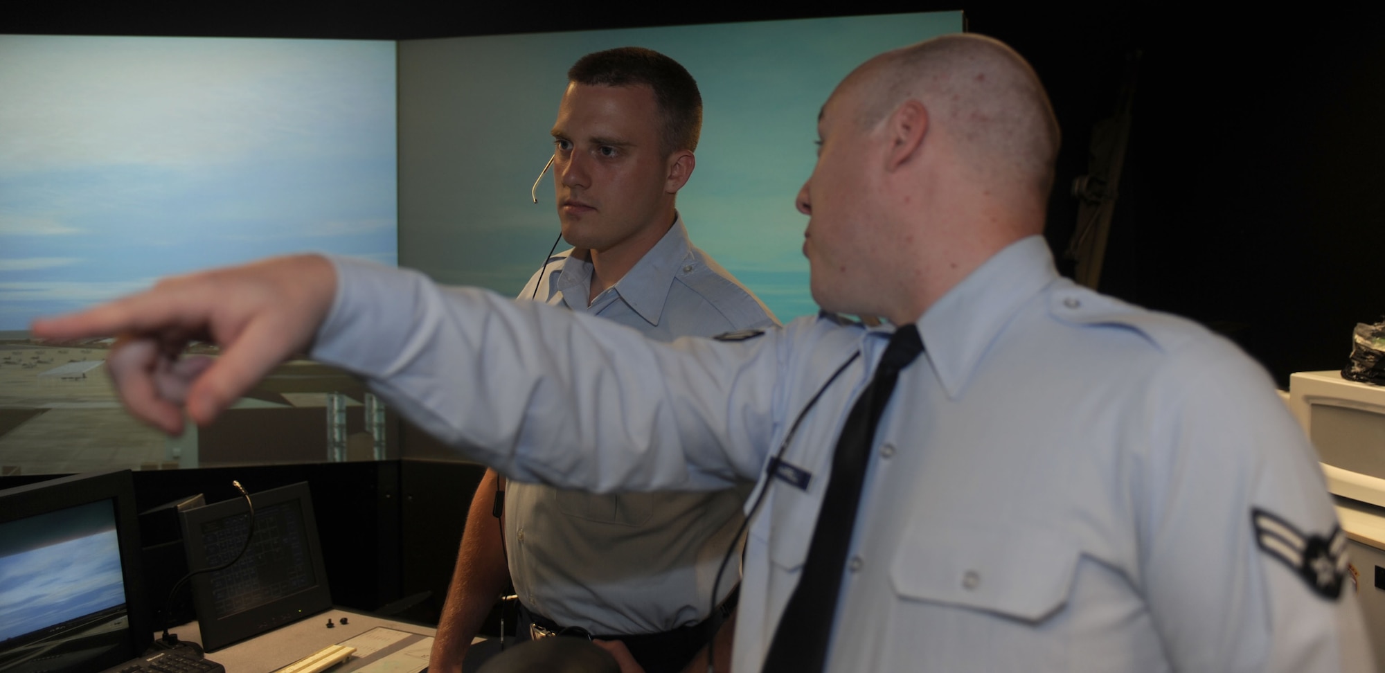 Airman 1st Class Sean Harrell, 1st Operations Support Squadron air traffic control apprentice, points out a new target during a training exercise at Langley Air Force Base, Va., June 4. As the local controller, Harrell tracks incoming and outgoing flight operations. (U.S. Air Force photo by Airman 1st Class Austin C. Harvill) 