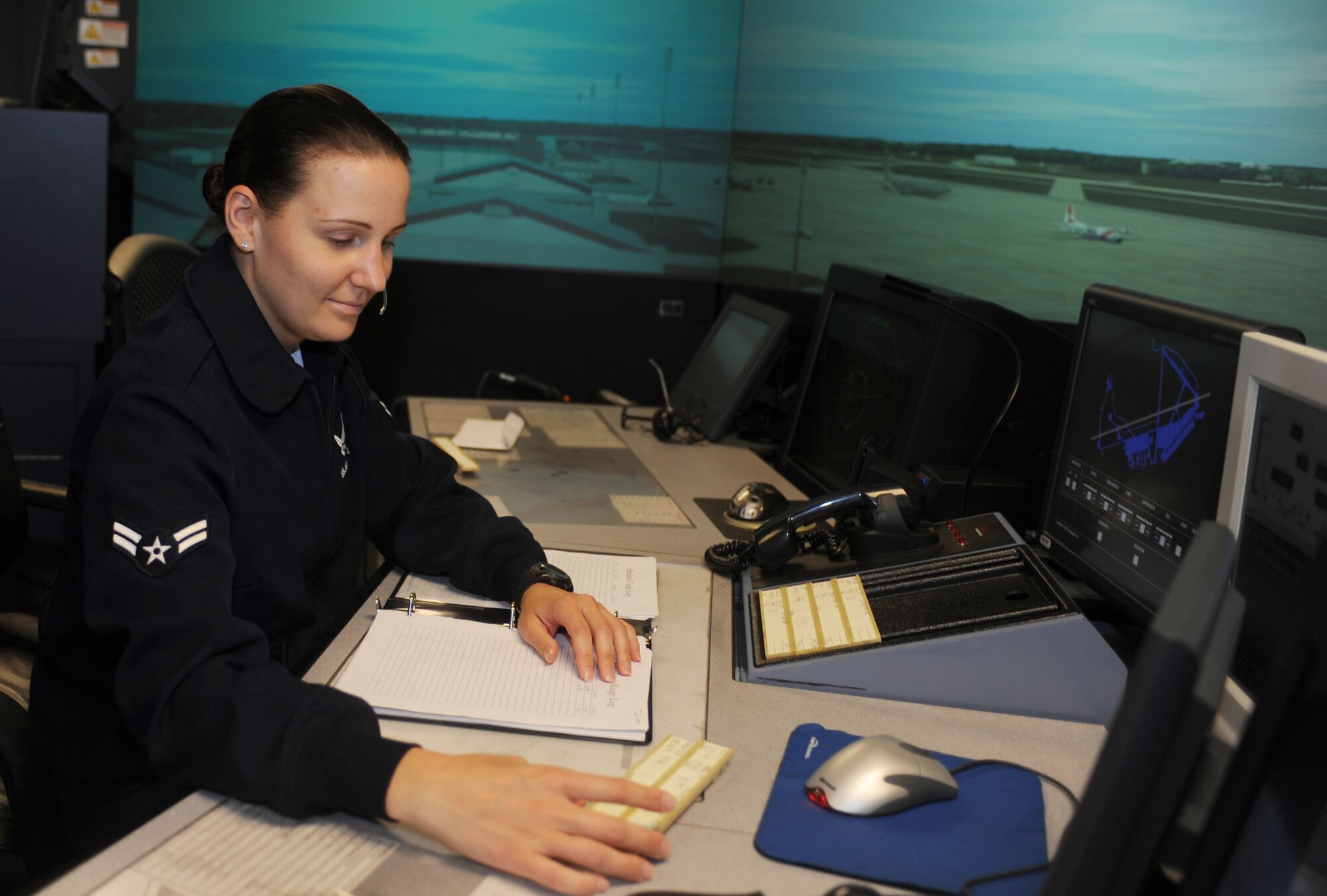 Airman 1st Class Erin Remus, 1st Operations Support Squadron air traffic control apprentice, works flight data during a training exercise at Langley Air Force Base, Va., June 4. Flight data is responible for relaying information from the flight line to the local and ground controllers. (U.S. Air Force photo by Airman 1st Class Austin C. Harvill) 