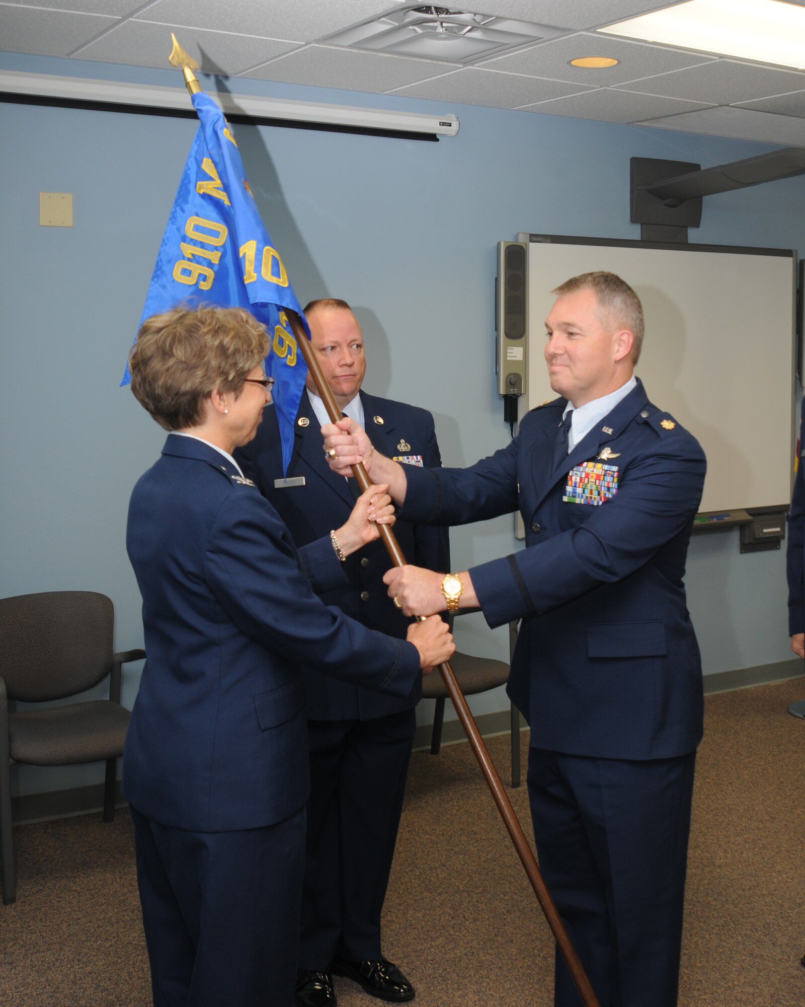 YOUNGSTOWN AIR RESERVE STATION, Ohio -- U.S. Air Force Reserve Col. Teresa Hams, 910th Mission Support Group commander, hands the 910th Communications Squadron (CS) guideon to Maj. Rick Basting, new 910th CS commander, during a change of command ceremony here June 2, 2012. Basting replaces outgoing commander Lt. Col. Peter Milkovich. (U.S. Air Force photo by Tech. Sgt. Matt Matulka)
