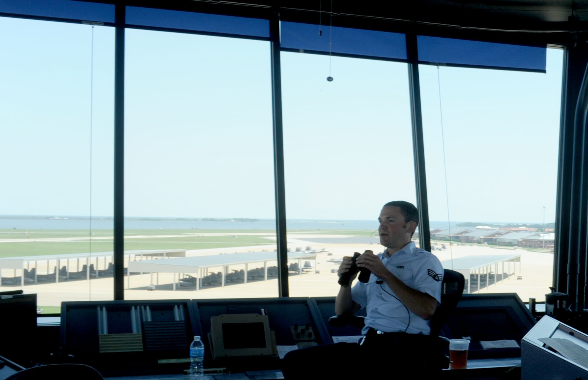 Senior Airman Christian Muri, 1st Operations Support Squadron air traffic control specialist, checks for debris on the flight line at Langley Air Force Base, Va., June 4. There are three positions in the air traffic control tower: the local controller, ground controller and flight data. (U.S. Air Force photo by Airman 1st Class Austin C. Harvill) 