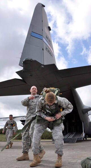 A U.S. Army parachute rigger helps ensure a U.S. Airman is ready to jump before boarding an Air Force Reserve C-130 June 3, 2012, to take part in a joint airdrop exercise outside the French village of Sainte Mere Eglise. U.S. and allied paratroopers, together with U.S., French and German aircrews and aircraft, took part in the large airdrop exercise as part of the 68th Anniversary of the Normandy D-Day invasion. The village of Saint Mere Eglise was one of the first towns liberated by 82nd and 101st Airborne paratroopers in the early morning hours of June 6, 1944. Every year, the Normandy region celebrates and remembers the sacrifices of U.S. and Allied forces to liberate the area. The aircraft is assigned to the 910th Airlift Wing based at Youngstown Air Reserve Base, Ohio. (U.S. Air Force photo/Staff Sgt. Stephen J. Collier)