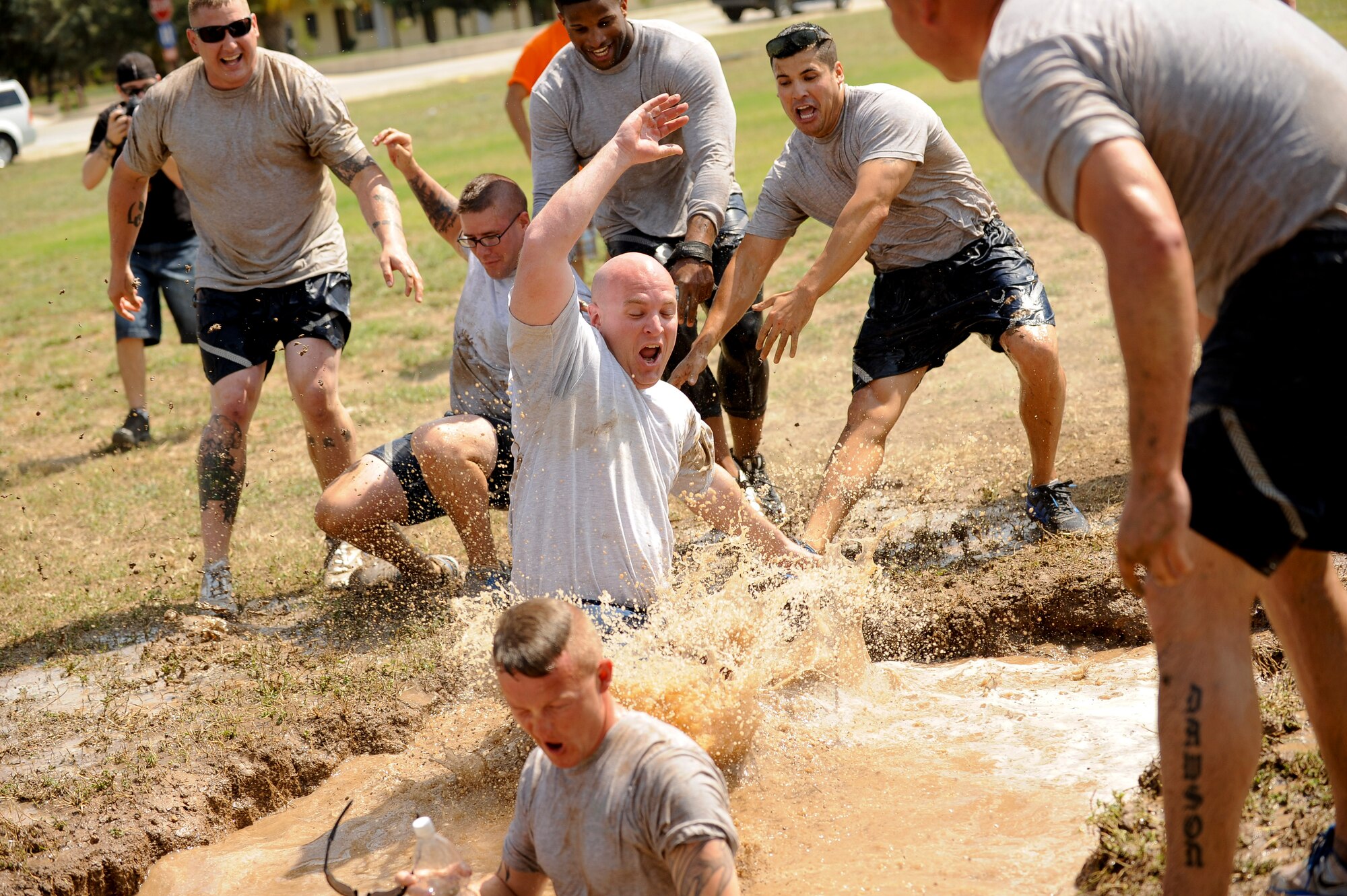 Members of the 39th Security Forces Squadron jump into the mud pit during the 39th Air Base Wing Sports Day tug-of-war event June 1, 2012, at Incirlik Air Base, Turkey. Sports day was an event that brought Airmen together through sports and recreation. Airmen from several squadrons competed in friendly games of volleyball, softball, basketball, kickball, dodgeball and tug-of-war. (U.S. Air Force photo by Senior Airman Jarvie Z. Wallace/Released)
