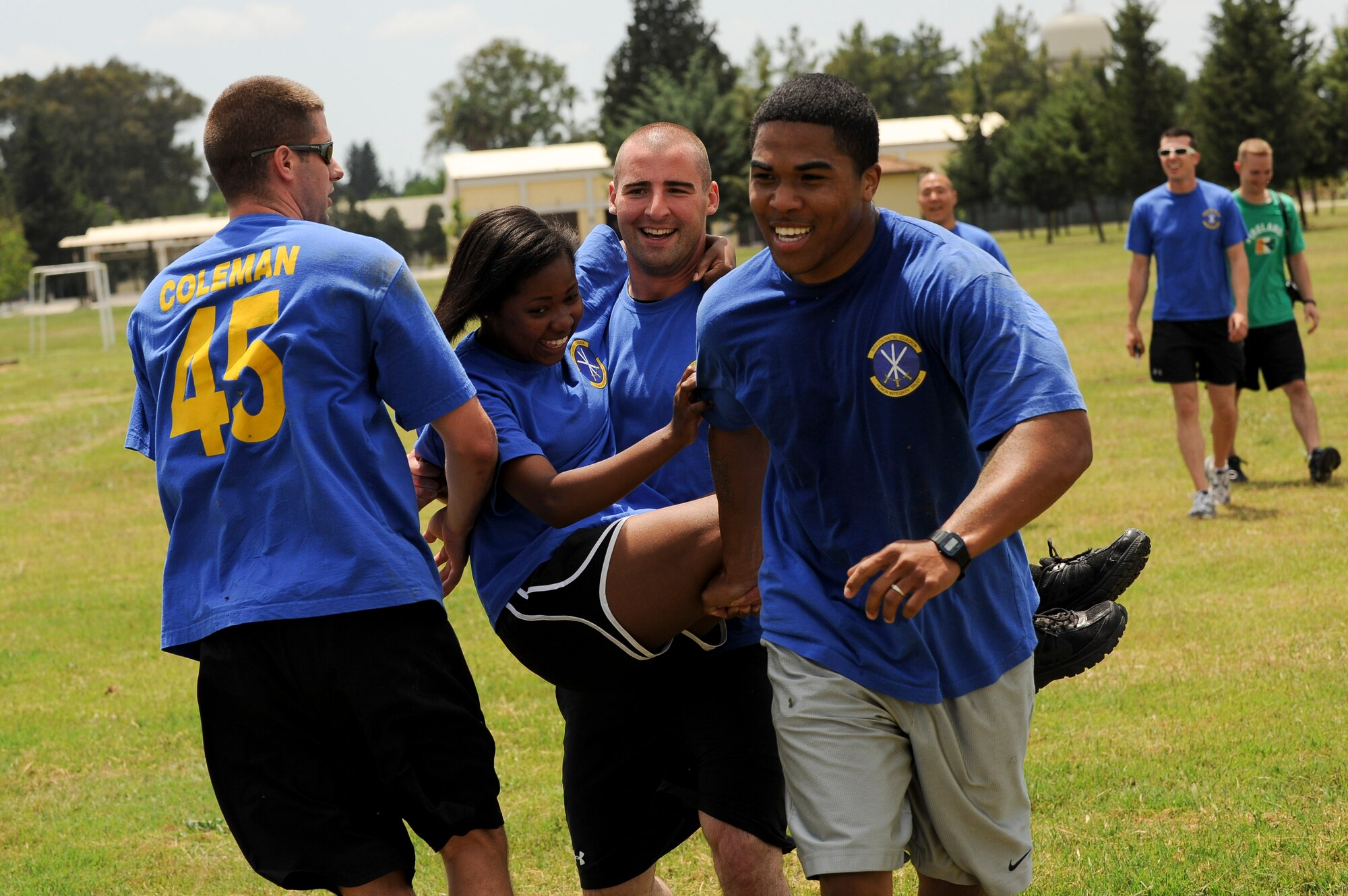 Members of the 39th Contracting Squadron, perform a three-man carry during the 39th Air Base Wing Sports Day obstacle course event June 1, 2012, at Incirlik Air Base, Turkey. Sports day was an event that brought Airmen together through sports and recreation. Airmen from several squadrons competed in friendly games of volleyball, softball, basketball, kickball, dodgeball and tug-of-war. (U.S. Air Force photo by Senior Airman Jarvie Z. Wallace/Released)
