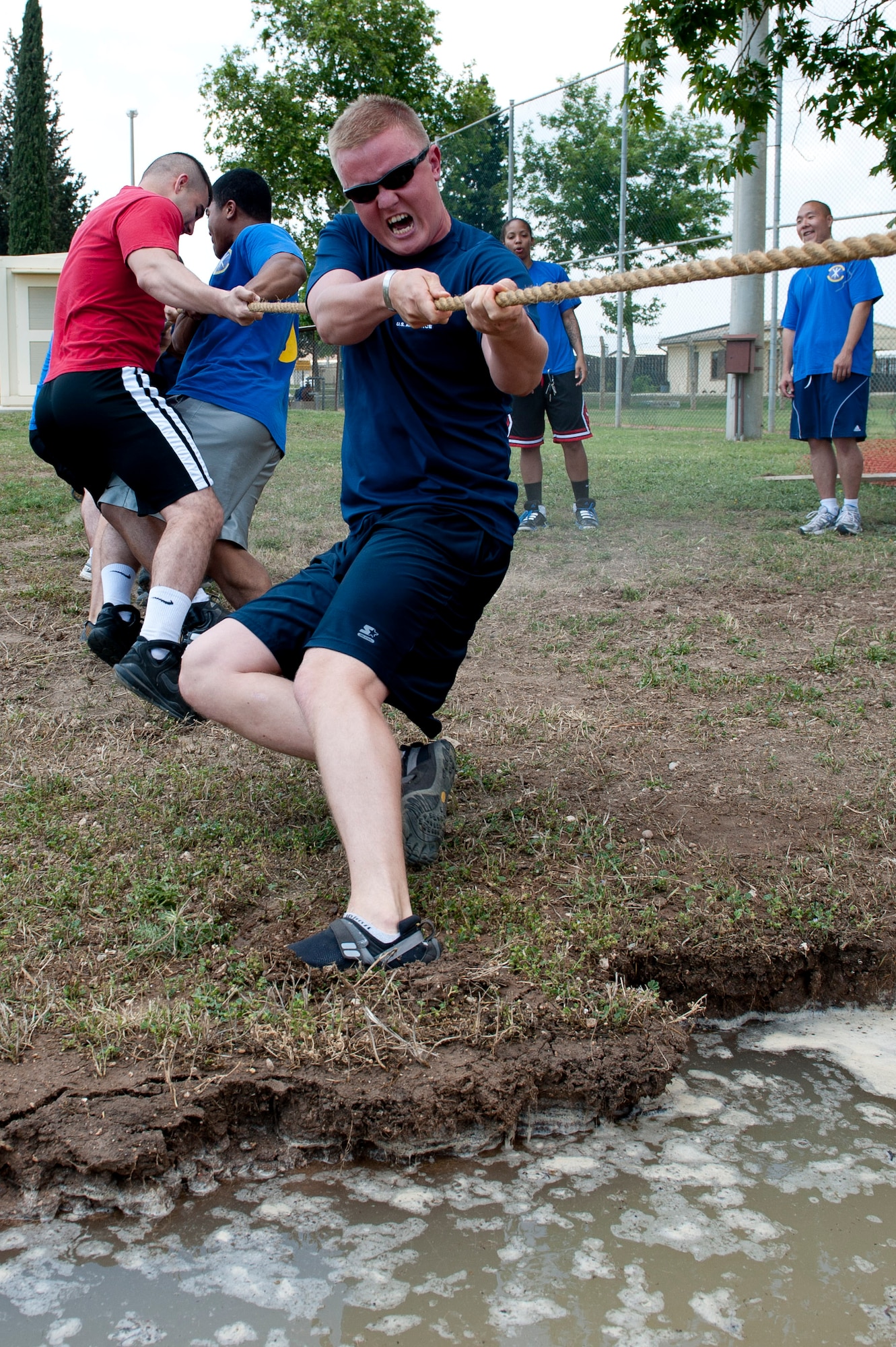The combined 39th Contracting Squadron and 39th Force Support Squadron team struggle to hold their footing with a game of tug-of-war during the 39th Air Base Wing Sports Day June 1, 2012, at Incirlik Air Base, Turkey. Sports day consisted of Incirlik Airmen competing in 13 different sporting events ranging from dodgeball and kickball to bowling and golf. (U.S. Air Force photo by Senior Airman Anthony Sanchelli/Released)
