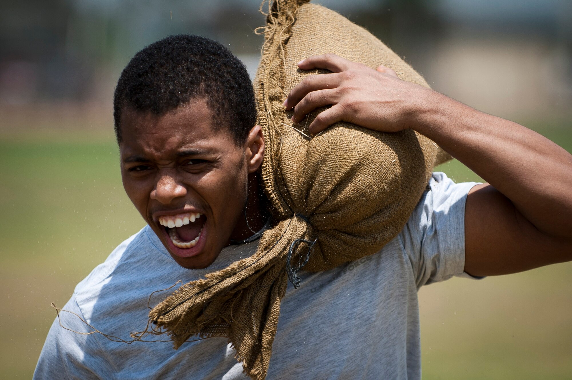 Joshua Vaughn, 39th Security Forces Squadron, carries a sandbag during the obstacle course portion of the 39th Air Base Wing Sports Day June 1, 2012, at Incirlik Air Base Turkey. Sports day consisted of Incirlik Airmen competing in 13 various sporting events ranging from dodgeball and kickball to bowling and golf. (U.S. Air Force photo by Tech. Sgt. Michael B. Keller/Released)