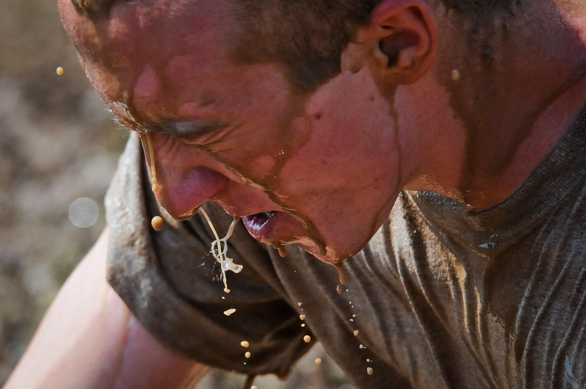 A member of the 39th Security Forces Squadron shakes muddy water from his head after jumping into a pit of water to celebrate the squadron's tug-of-war victory June 1, 2012 at Incirlik Air Base, Turkey. The 39th Air Base Wing Sports Day was designed to build teamwork and camaraderie among different work sections by competing in various sporting events for the commander's trophy. (U.S. Air Force photo by Senior Airman Marissa Tucker/Released)
