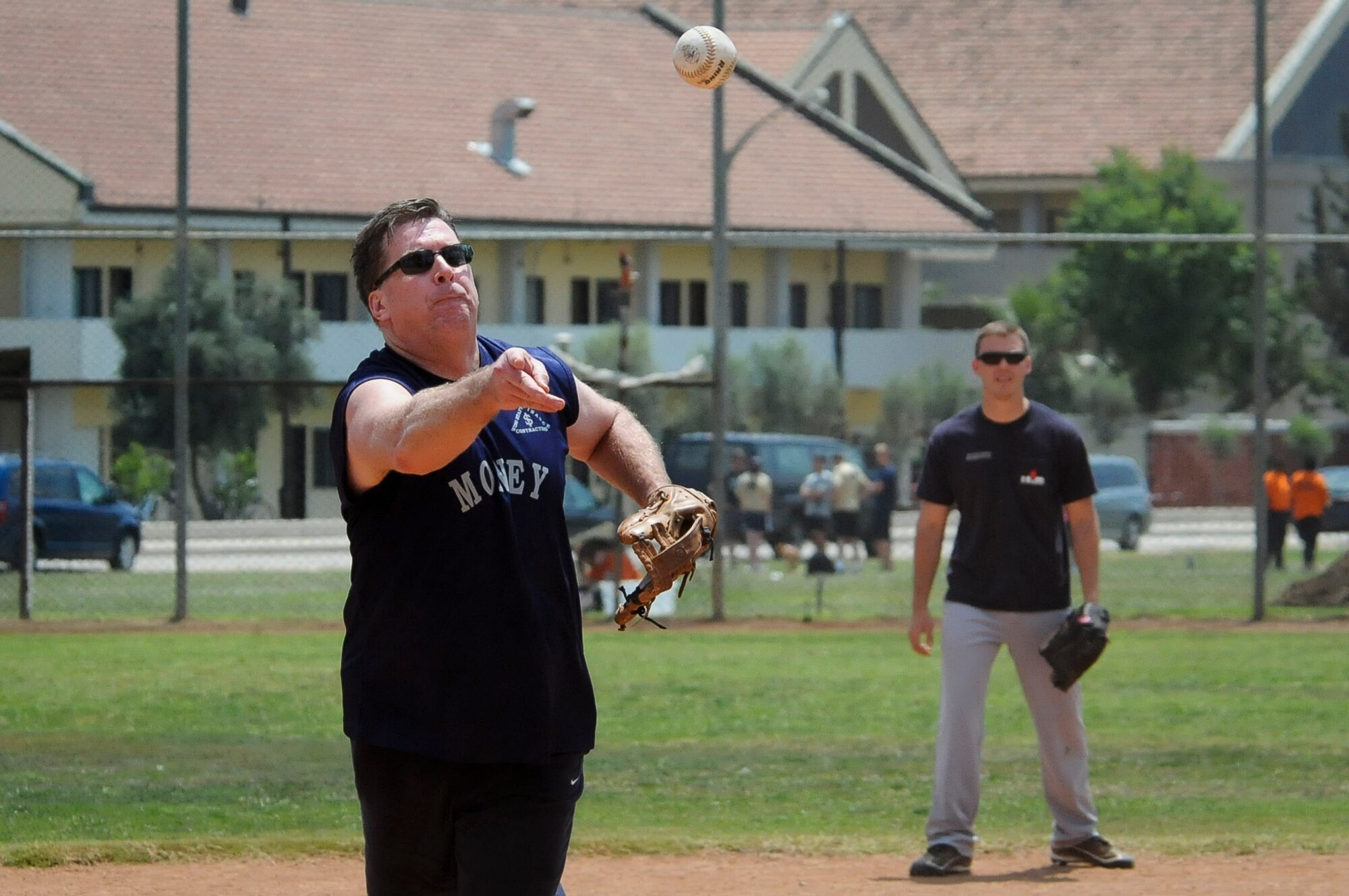 A member of the 39th Contracting Squadron attempts to strike out a batter during a softball game June 1, 2012, at Incirlik Air Base, Turkey. The game was part of the 39th Air Base Wing Sports Day, which allowed Airmen to participate in sports such as kickball, soccer and dodge ball during the duty day. (U.S. Air Force photo by  Senior Airman Marissa Tucker/Released)