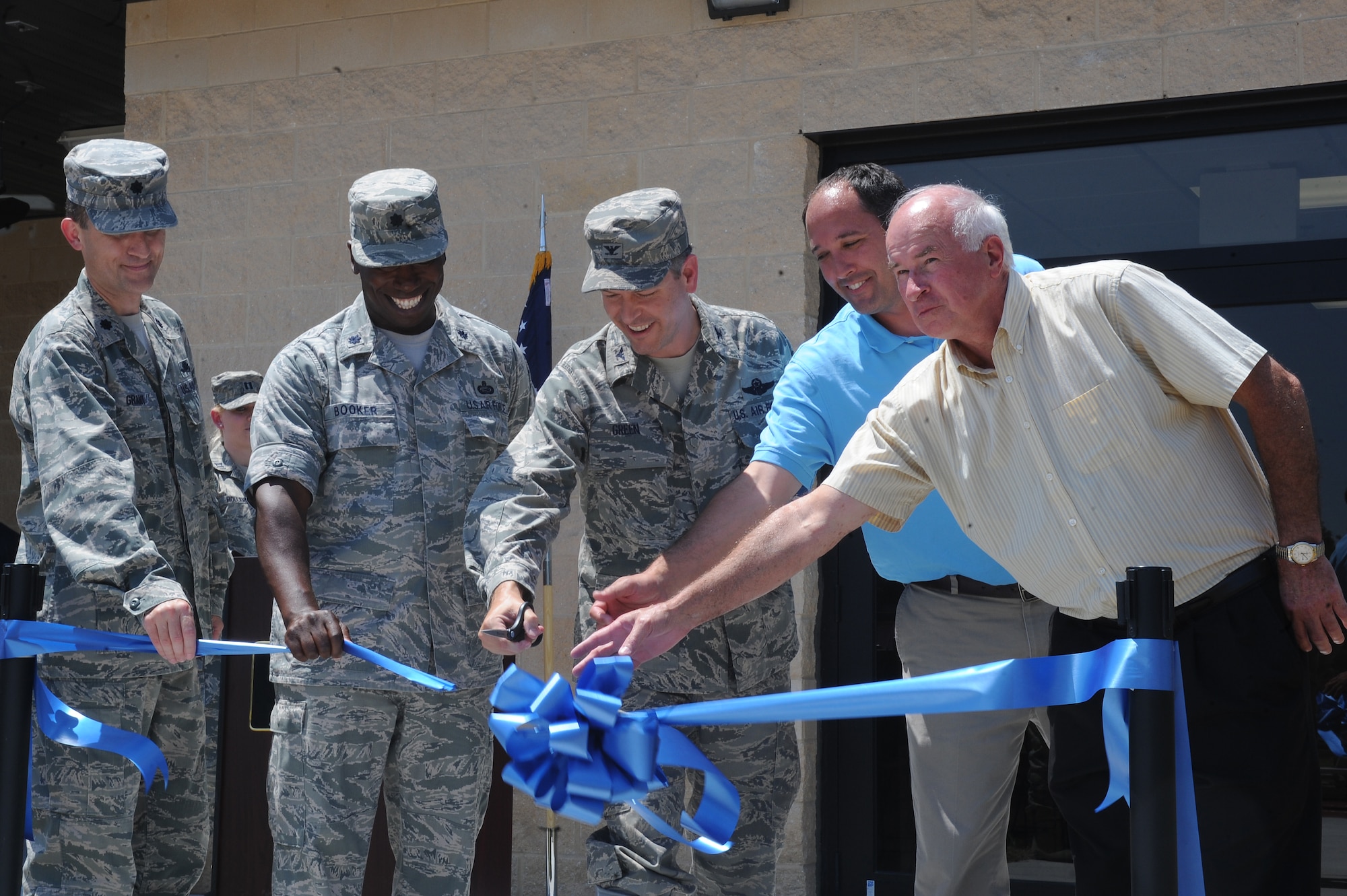 U.S. Air Force Col. Vann Green cuts the ribbon during the opening ceremony of the fitness assessment cell building on Seymour Johnson Air Force Base, N.C., May 31, 2012. The new facility will accommodate the physical training testing of up to 30 Airmen at one time. Green is the 4th Fighter Wing vice commander. (U.S. Air Force photo/Airman 1st Class John Nieves Camacho/Released)
