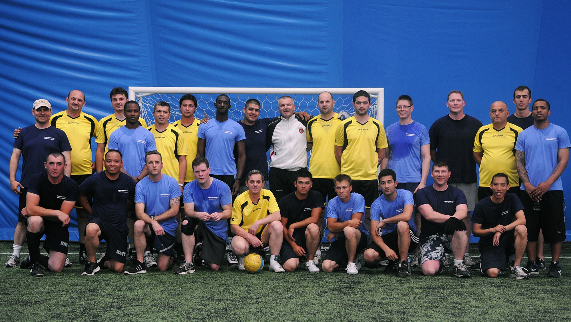 CAPLJINA, Bosnia and Herzegovina -- U.S. military members, including members of the 48th Fighter Wing, participating in Shared Resilience 2012 and the Municipal of Capljina soccer team pose for a group photo at the Sports Center Capljina June 1, 2012. The local team won the match 20-2. More than 500 military members from nine nations are participating in SR12, the annual U.S. Joint Chiefs of Staff sponsored medical exercise, May 28 - June 8. The goals of the exercise are to strengthen interoperability, facilitate training in crisis response and disaster management, and validate the readiness of deployable military medical and humanitarian assistance teams. The exercise, in the spirit of partnership for peace, directly supports U.S. European Command's theater cooperation efforts and strategy for active security with European countries. (U.S. Air Force photo by Staff Sgt. Tabitha Lee)