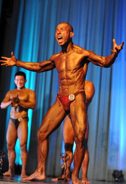 Hidekazu Taba yells to the crowd in excitement after winning his second award during the 6th Annual Pacific Muscle Classic on Kadena Air Base, Japan, June 3, 2012. Taba won the Men's Masters as well as "crowd favorite" with his muscles and witty personality. (U.S. Air Force photo/Airman 1st Class Justin Veazie)