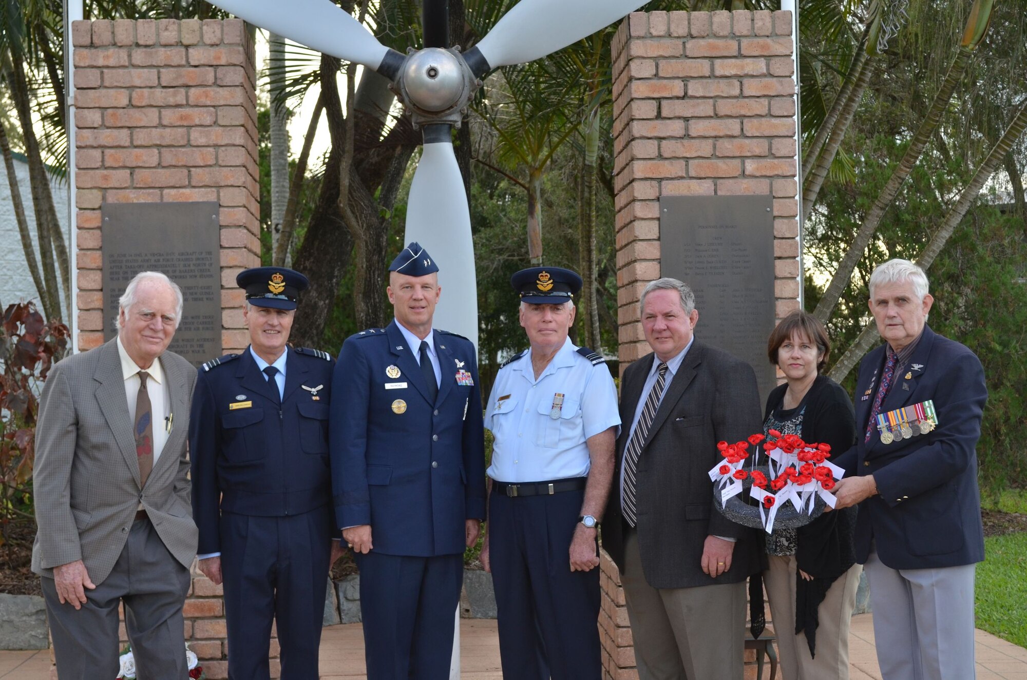 MACKAY, Australia -- Maj. Gen. Jay Raymond, center, Fifth Air Force Vice Commander, poses for a picture here June 3, 2012, along with various Royal Australian Air Force leaders and civilian members of the Bakers Creek Memorial committee. The group is standing in front of a monument in honor of the 40 Fifth Air Force members who died in a plane crash there in 1943 during World War II.  This year marked the 20th anniversary of the dedication of the monument. (Courtesy photo) 