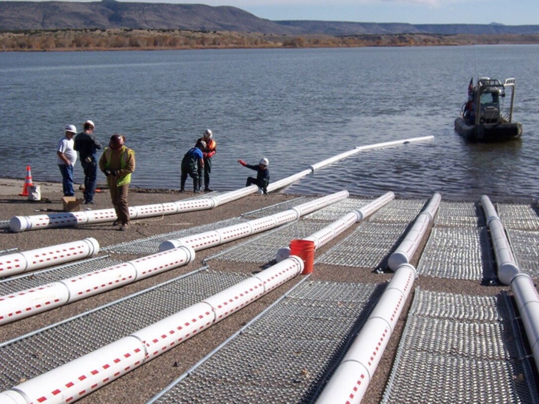 The Corps installed 50, 20-foot-long log booms in the canyon portion of Cochiti Lake, a half mile upstream of the Tetilla boat ramp, to catch debris. 