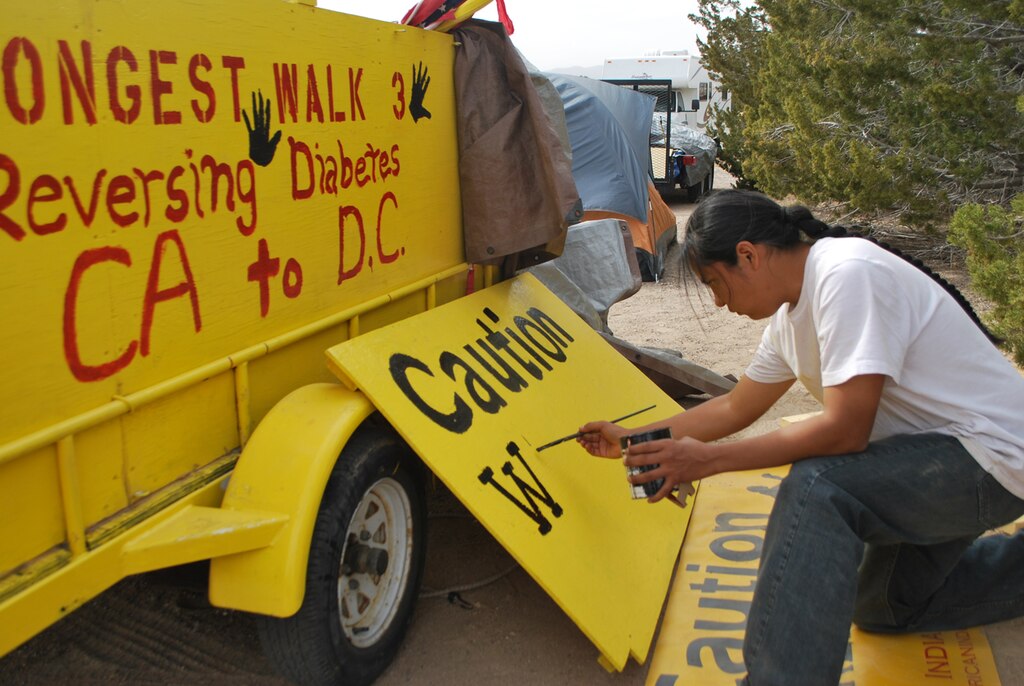Navajo Artist Julius Badoni, a member of the Longest Walk team, creates a sign to be used on a truck accompanying walkers.
