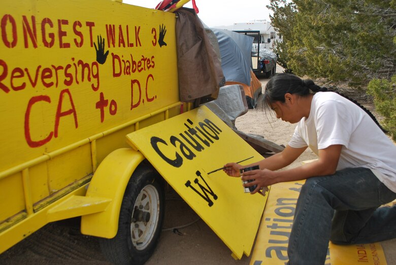 Navajo Artist Julius Badoni, a member of the Longest Walk team, creates a sign to be used on a truck accompanying walkers.