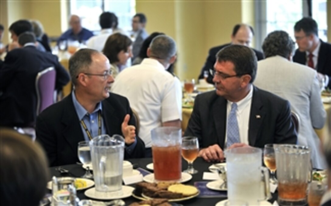 Commander, U.S. Cyber Command and Director, National Security Agency Gen. Keith Alexander (left) talks to Deputy Secretary of Defense Ashton B. Carter during lunch at the Senior Conference XLIX in the United States Military Academy at West Point, N.Y., on June 4, 2012.  Carter is the keynote speaker for the conference, which provides a forum for distinguished representatives from the private sector, government, academia, the think-tank community, and the joint military services to discuss topics of national security importance.  