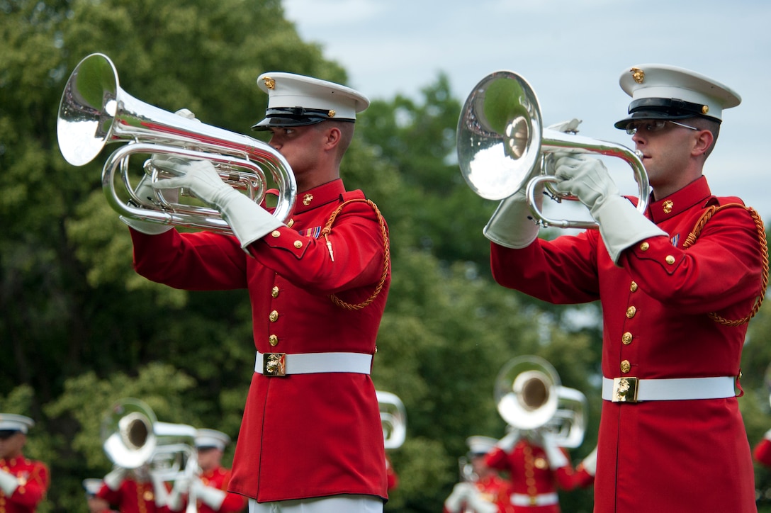 Sgt. David Cox, U.S. Marine Drum & Bugle Corps baritone player, and Cpl. Joshua Holland, mellophone player, perform during a Tuesday Sunset Parade at the Marine Corps War Memorial in Arlington, Va., June 5.