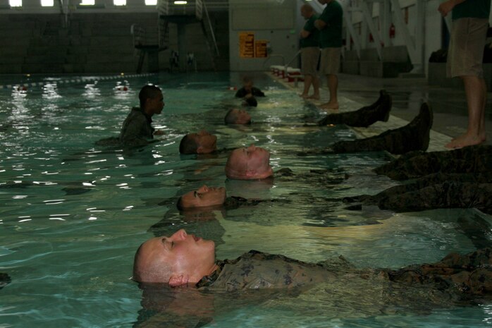 Recruits of Company G, 2nd Recruit Training Battalion, learn to confidently float on their backs before learning five different swimming techniques they will use to swim 25 meters across the pool May 22 at the swim tank aboard Marine Corps Recruit Depot San Diego. Recruits learn the importance of combat water survival during Week Four of recruit training. 