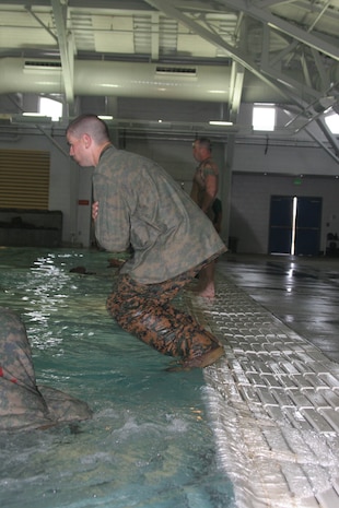 A recruit of Company G, 2nd Recruit Training Battalion, jumps into the water before swimming 25 meters across the pool May 22 at the swim tank aboard Marine Corps Recruit Depot San Diego. Recruits learn the importance of combat water survival in recruit training because the probability of them being stationed in aquatic environments is high.