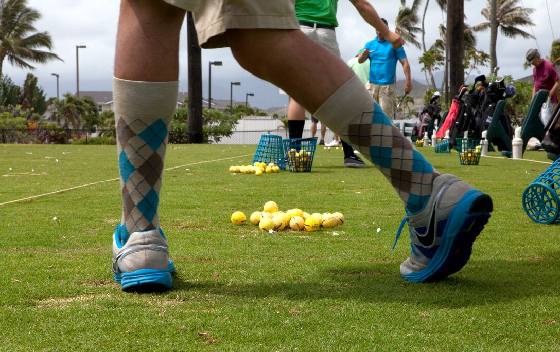 MARINE CORPS BASE, Hawaii – Lance Cpl. George A. Reynoso, a vehicle operator for the motor transportation section, Headquarters and Service Battalion, U.S. Marine Corps Forces, Pacific, takes some practice shots before teeing off in the 4th Annual MarForPac Golf Tournament at Kaneohe Klipper Golf Course here, June 1. “(This tournament) is great for morale, and we’re pumped,” said Reynoso, 21, from Ventura, Calif. “I went out and bought these socks, so I’m definitely ready.” The afternoon golf outing gave MarForPac service members and civilian personnel a unique opportunity to build unit cohesion outside the workplace.
