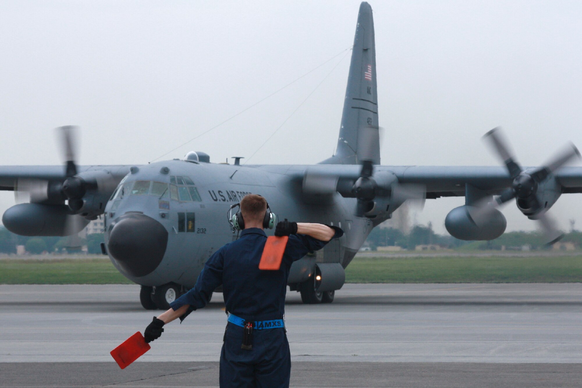 YOKOTA AIR BASE, Japan -- Staff Sgt. Jonathan Callahan, 374th Aircraft Maintenance Squadron crew chief, marshalls a C-130 Hercules during the Samurai Surge exercise at Yokota Air Base, Japan, on June 5, 2012. (Courtesy photo by Chiyo Sakai)